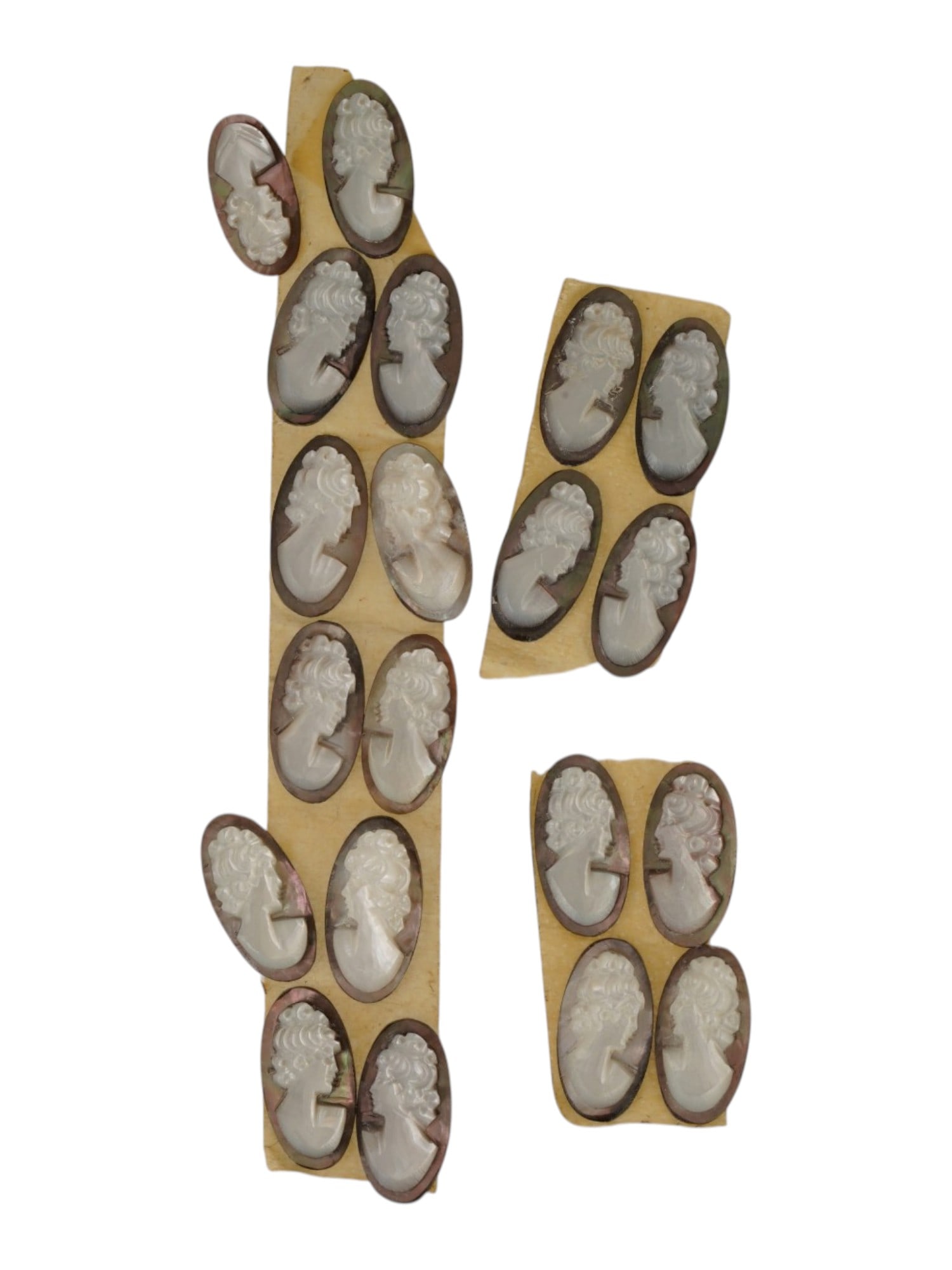 COLLECTION OF VINTAGE UNMOUNTED SHELL CAMEO CARVINGS: A collection of vintage unmounted shell cameo carvings. The hand-carved cameos depict classical female profile portraits with detailed hairstyles in the Victorian tradition. Intended for brooches, pen