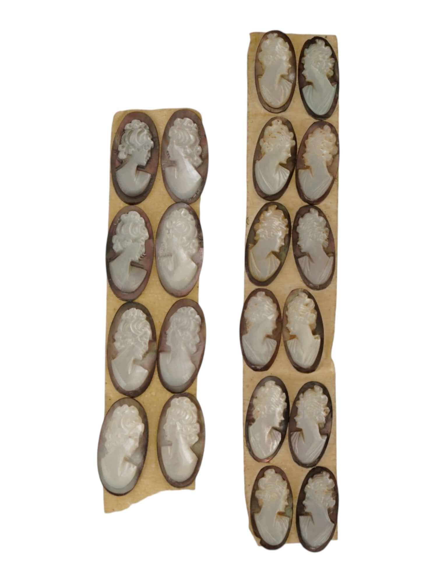 COLLECTION OF VINTAGE UNMOUNTED SHELL CAMEO CARVINGS: A collection of vintage unmounted shell cameo carvings. The hand-carved cameos depict classical female profile portraits with detailed hairstyles in the Victorian tradition. Intended for brooches, pen