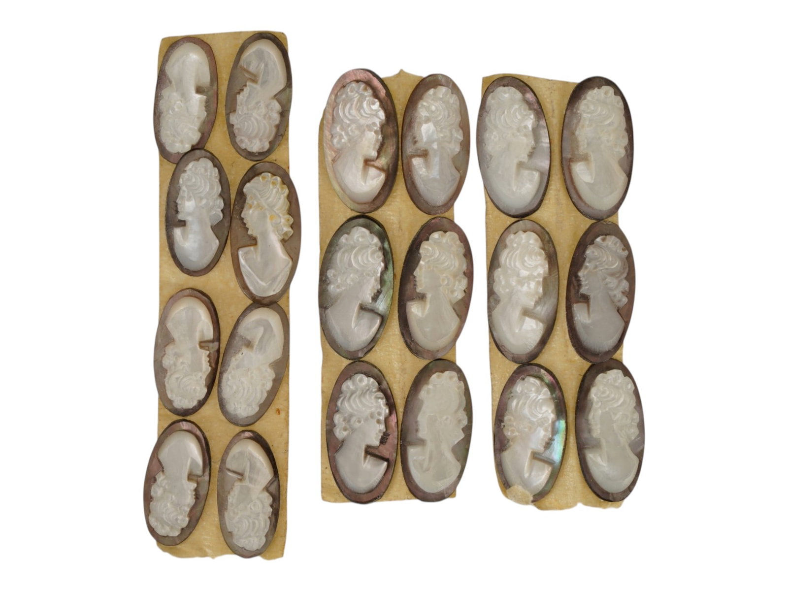COLLECTION OF VINTAGE UNMOUNTED SHELL CAMEO CARVINGS: A collection of vintage unmounted shell cameo carvings. The hand-carved cameos depict classical female profile portraits with detailed hairstyles in the Victorian tradition. Intended for brooches, pen