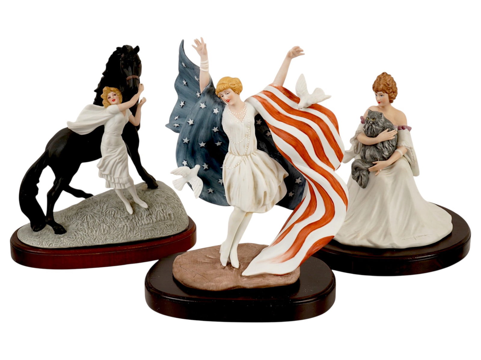 GROUP OF 3 LOUIS ICART HAND PAINTED PORCELAIN FIGURINES: A group of three Louis Icart hand-painted porcelain figurines, produced by The Heirloom Tradition during the mid-1980s. It includes a 1930 Jeunesse figurine, 1927 Miss America figurine, 1929 Le Chat P
