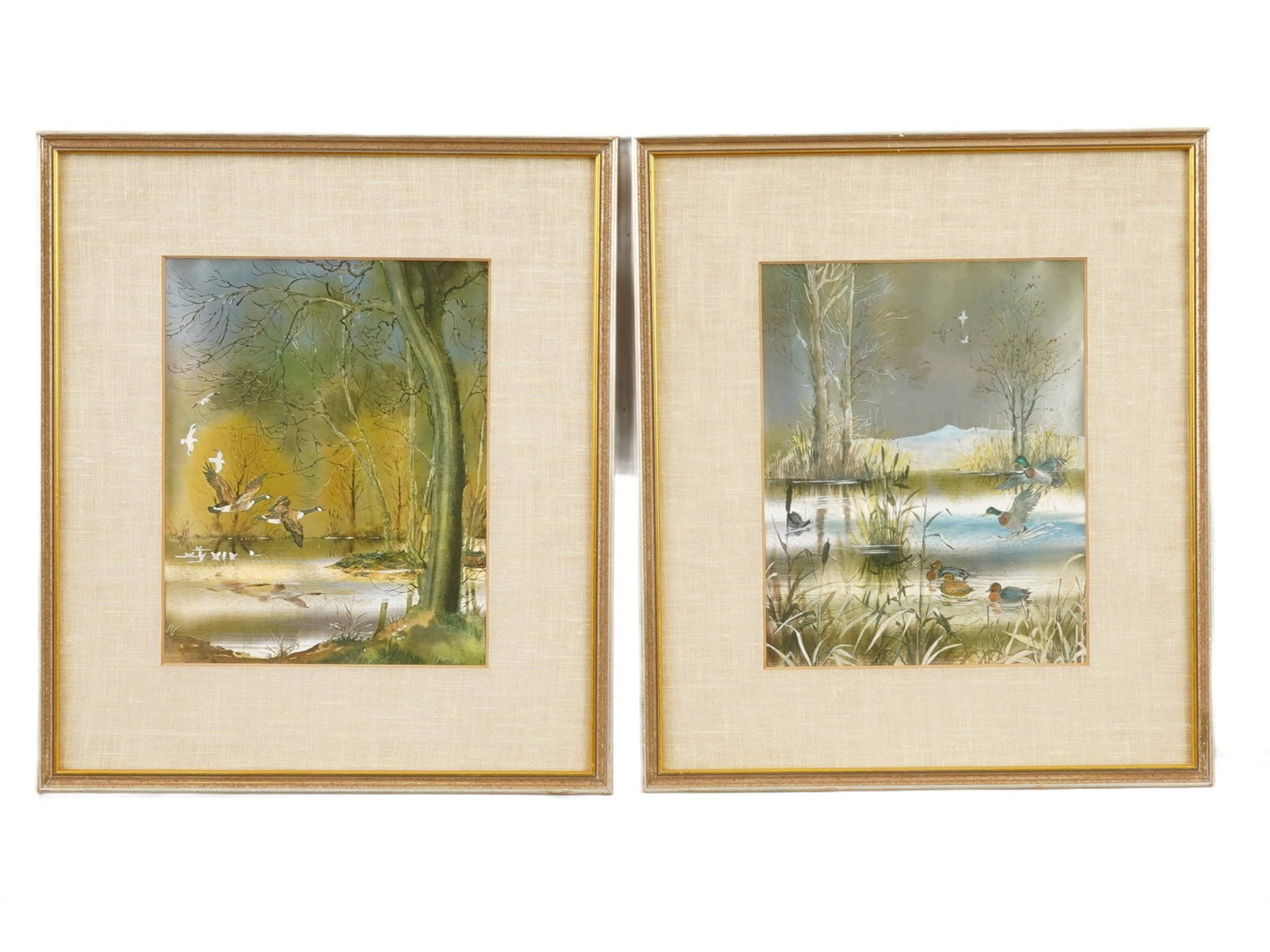 VINTAGE PRINTS ON FABRIC LANDSCAPE WITH GEESE: A pair of matching color prints on fabric, lake landscapes with geese. Unsigned. Matted and framed. Collectible Art Prints And Wall Decor. THIS LOT IS ELIGIBLE FOR A 30-DAY UNCONDITIONAL RETURN FROM T