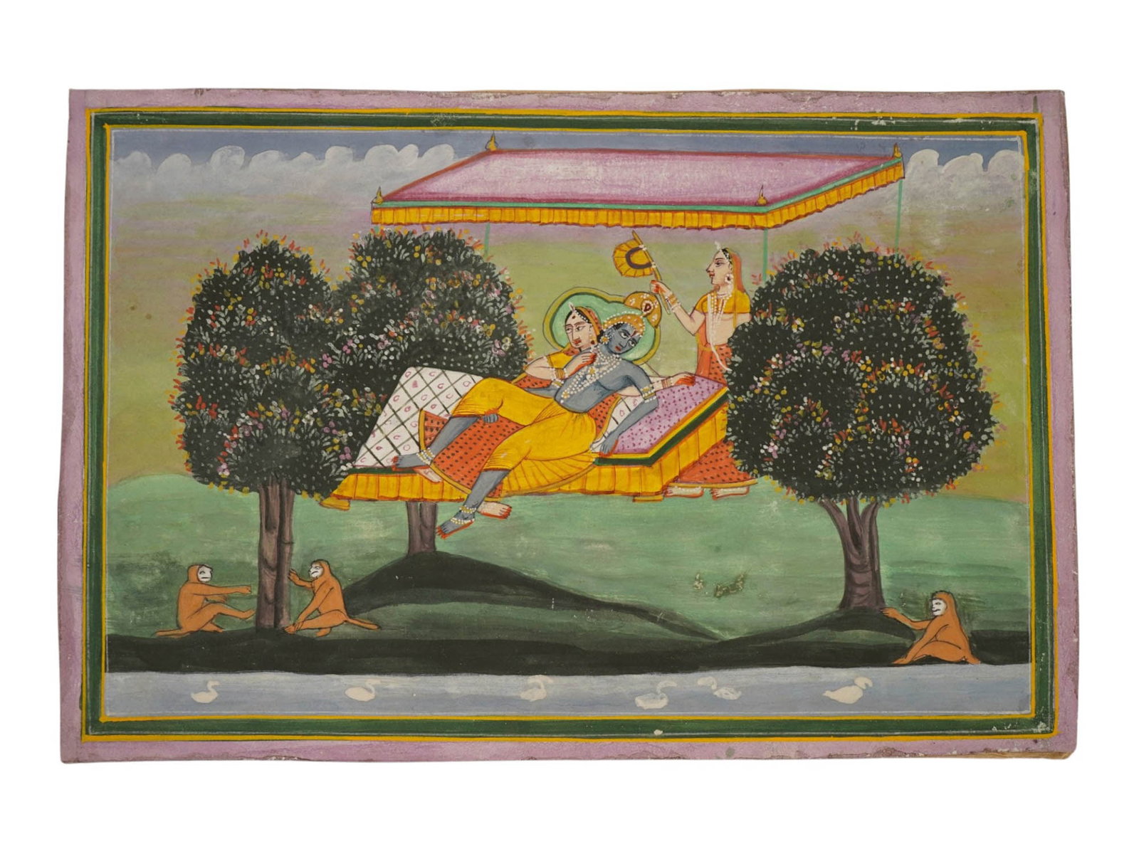 ANTIQUE INDIAN MUGHAL EMPIRE MINIATURE PAINTING: An antique Indian miniature painting. Late Mughal Empire period, 18th to 19th century. Kangra School. Watercolor and ink on paper. Horizontal format. Lord Krishna and his consort Radha with an attenda