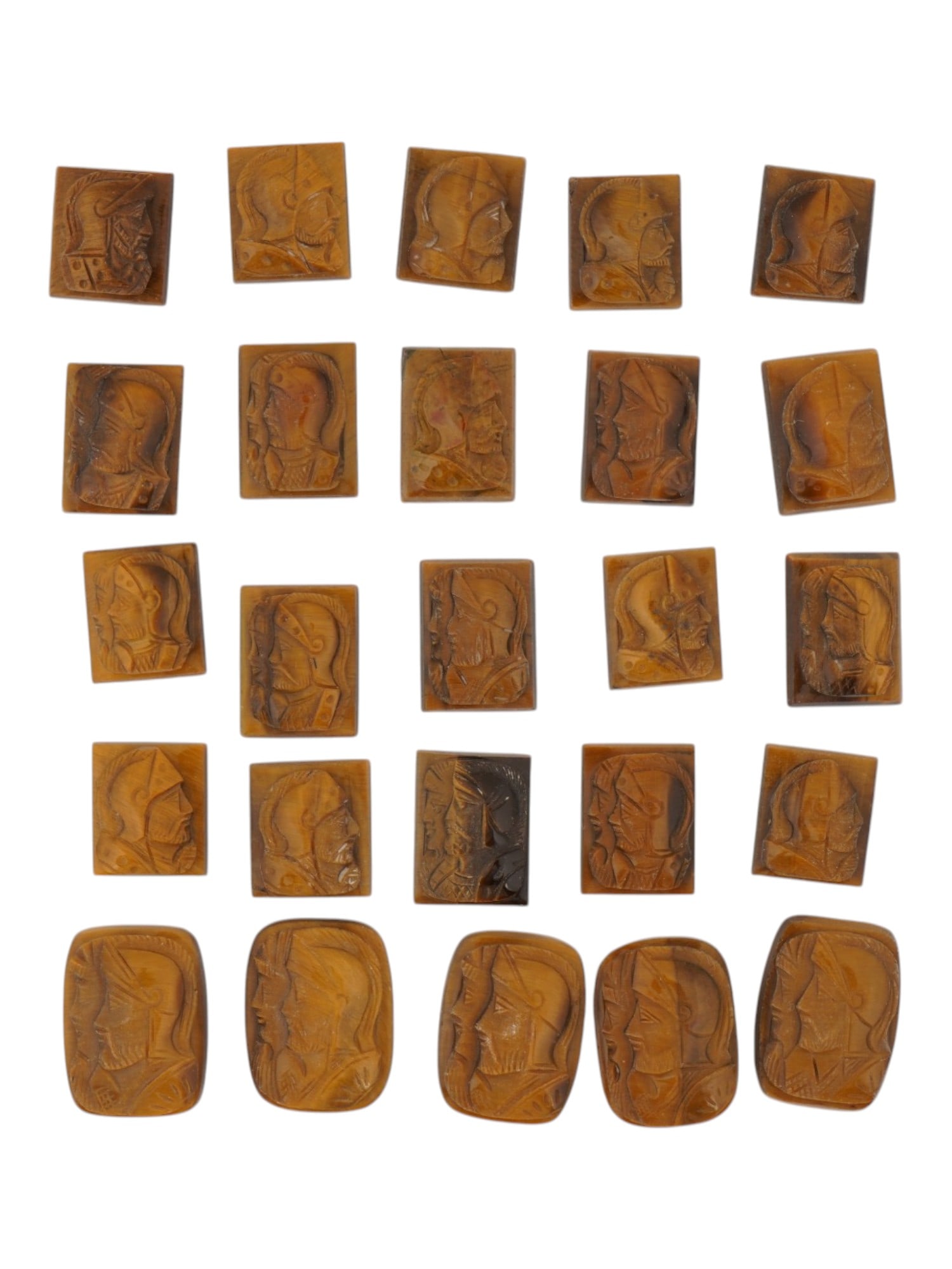 LOT OF WARRIORS PORTRAITS CARVED TIGER EYE CAMEOS: A collection of twenty five vintage cameos in various shapes. Each cameo with a rectangular or oval hand carved Tiger eye panel with relief portrait of a Roman warrior in profile. Vintage Jewelry And 
