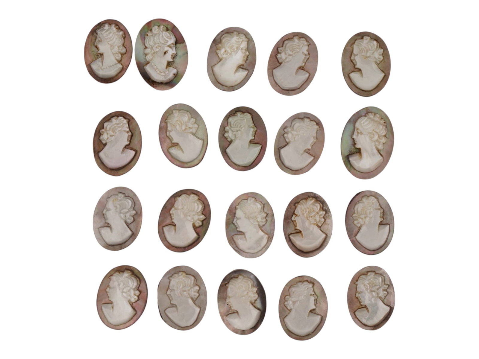 COLLECTION OF HAND CARVED SHELL CAMEO MEDALLIONS: A collection of vintage hand carved cameo medallions. A total of 20 items. Each piece is crafted from conch shell featuring a female portrait in the Victorian and Roman manner rendered in high relief.