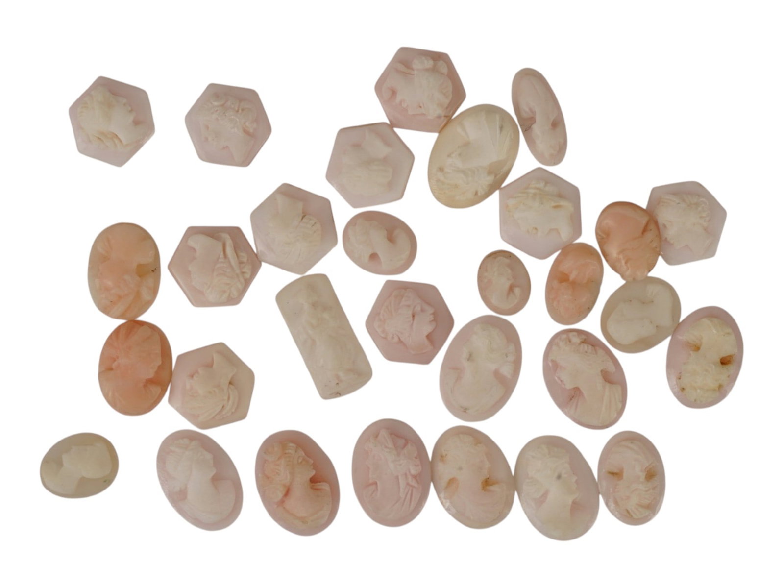 COLLECTION OF HAND CARVED CORAL CAMEO MEDALLIONS: A collection of vintage hand carved cameo medallions. A total of 30 items. Each piece is crafted from coral featuring a female portrait in the Victorian and Roman manners rendered in high relief. The 