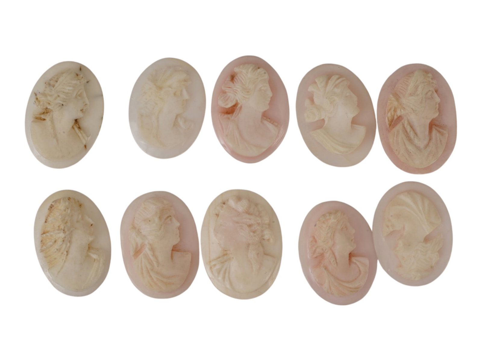 COLLECTION OF HAND CARVED CORAL CAMEO MEDALLIONS: A collection of vintage hand carved cameo medallions. A total of 10 items. Each piece is crafted from coral featuring a female portrait in the Victorian and Roman manners rendered in high relief. The 