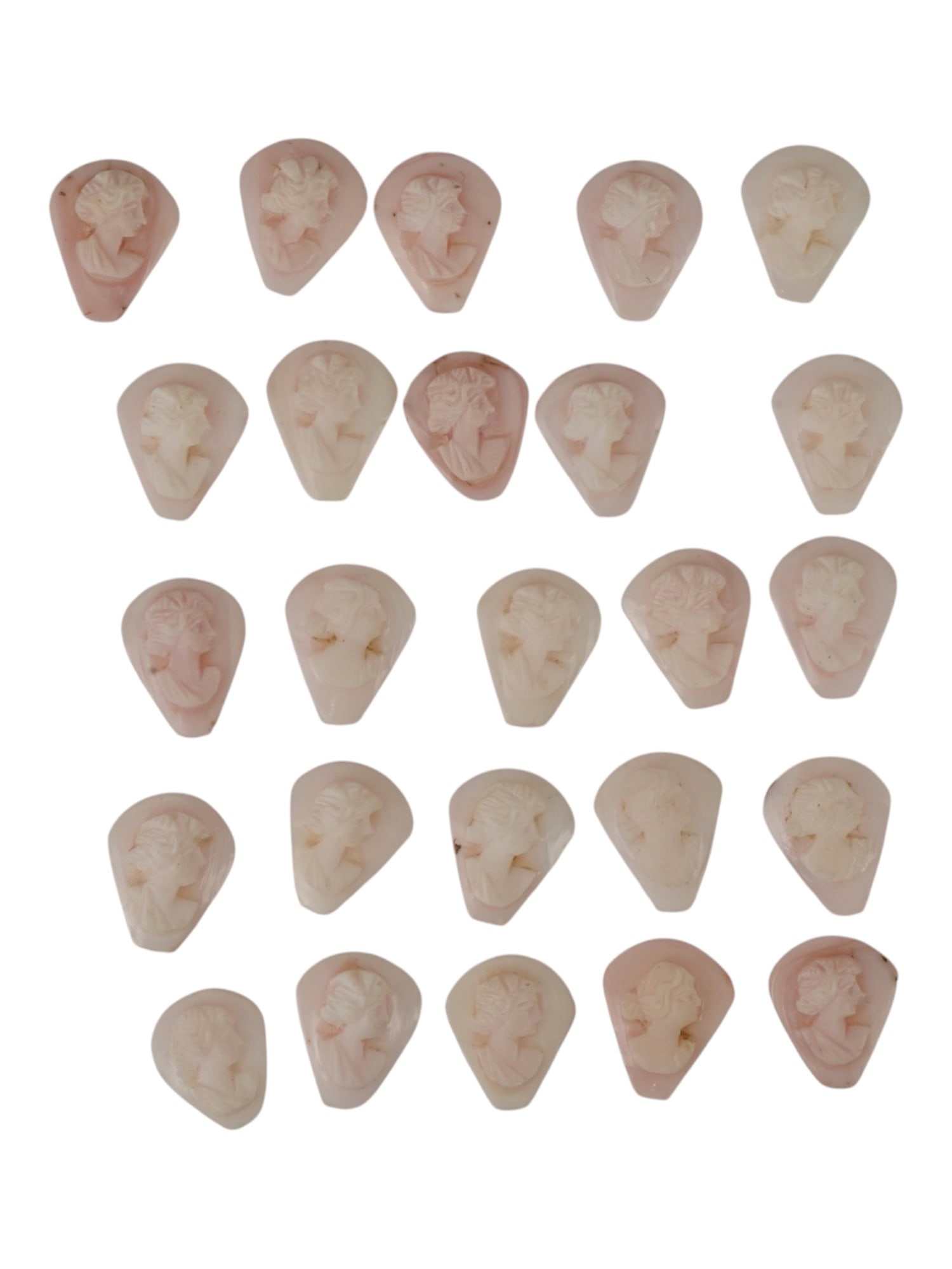 COLLECTION OF HAND CARVED CORAL CAMEO MEDALLIONS: A collection of vintage hand carved cameo medallions. A total of 25 items. Each piece is crafted from coral featuring a female portrait in the Victorian manner rendered in high relief. The cameos are 