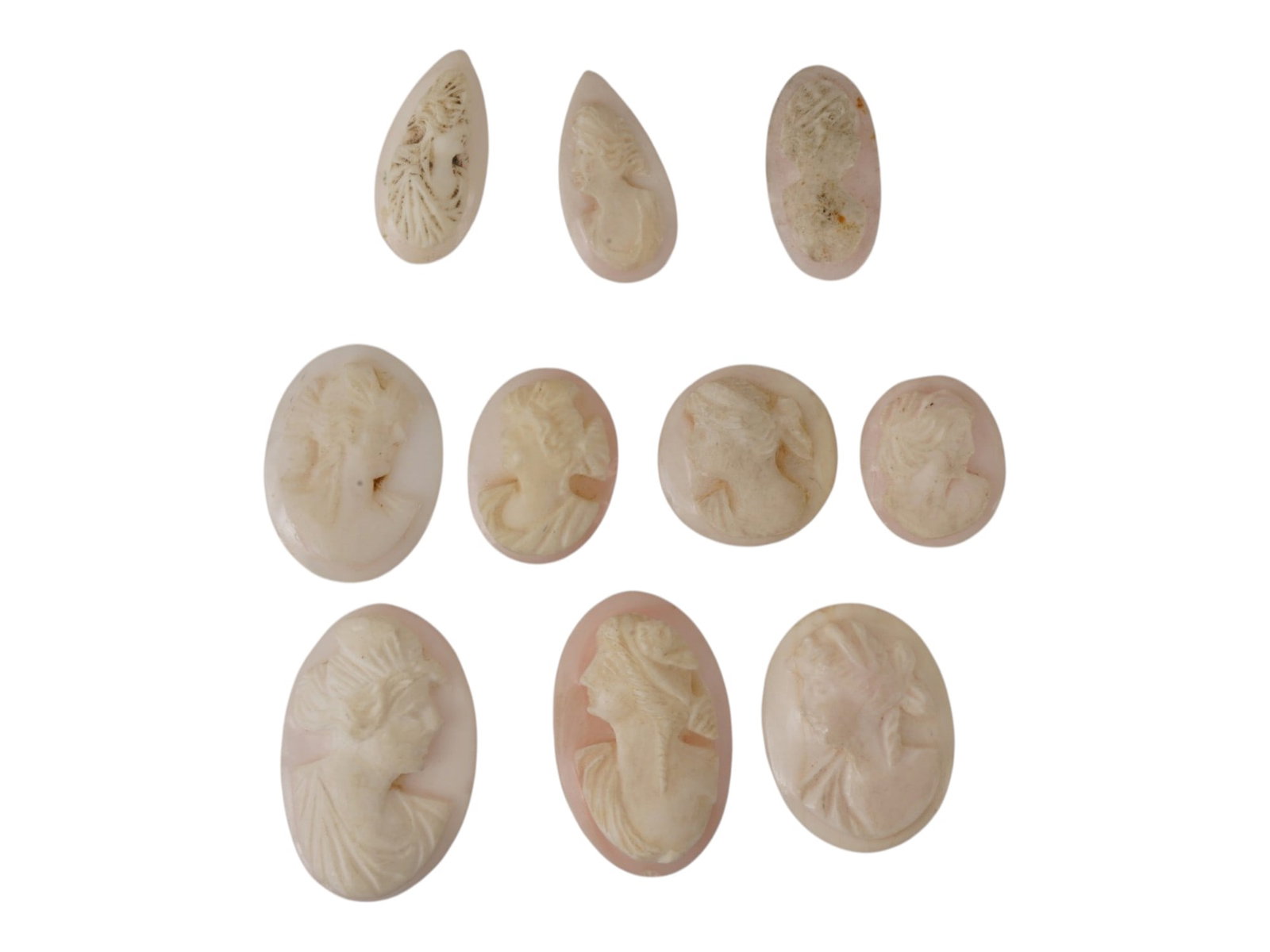 COLLECTION OF VINTAGE HAND CARVED SHELL CAMEOS: A collection of 10 vintage hand-carved shell cameos featuring classical female portrait profiles, including 2 teardrop-shaped pieces, 1 narrow vertical oval, and 7 traditional oval cabochons of varyin