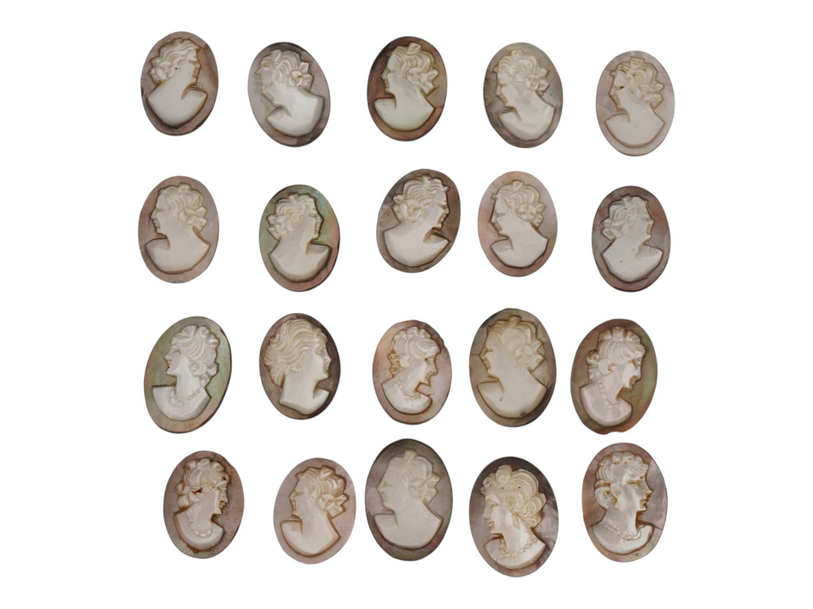 LOT OF FEMALE PORTRAIT CARVED SHELL CAMEOS: A lot of 20 hand carved conch shell cameos. Each piece depicts a female profile portrait rendered in high relief. Oval shape. Collectible Jewelry And Glyptic Art, Sculpture. THIS LOT IS ELIGIBLE FOR A