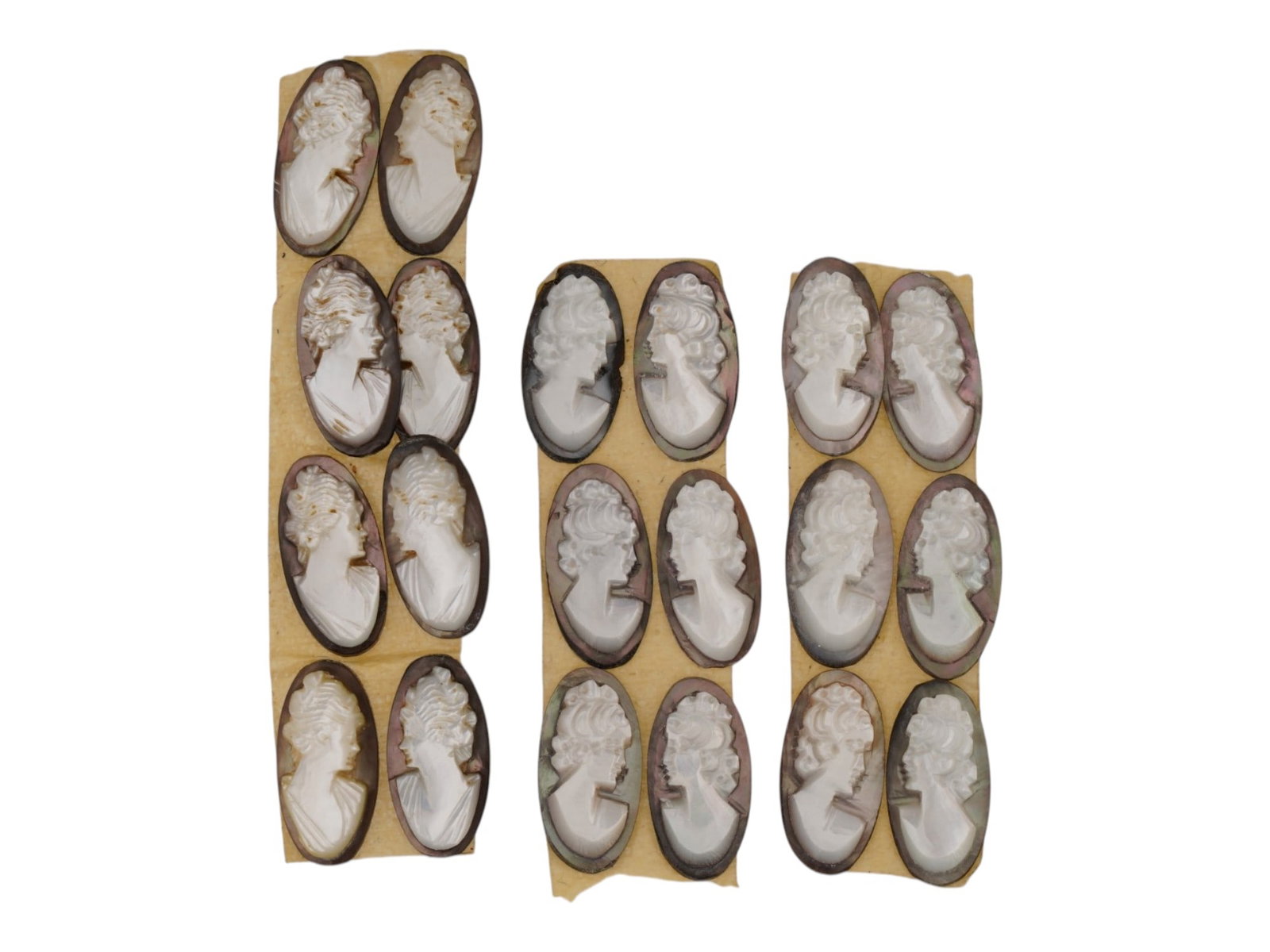 LOT OF FEMALE PORTRAIT CARVED SHELL CAMEOS: A lot of 20 hand carved conch shell cameos. Each piece depicts a female profile portrait rendered in high relief. Elongated oval shape. Collectible Jewelry And Glyptic Art, Sculpture. THIS LOT IS ELIG