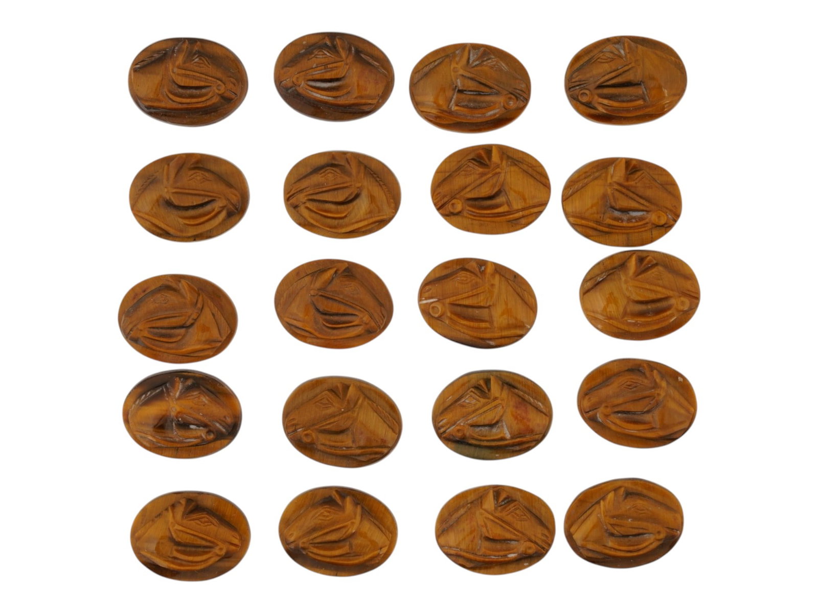 COLLECTION OF VINTAGE HAND CARVED TIGERS EYE CAMEOS: A collection of 20 vintage hand-carved tigers eye cameos, each an oval featuring a right-facing horse head in relief. The natural golden-brown chatoyancy gives the mane and musculature a shimmering, t