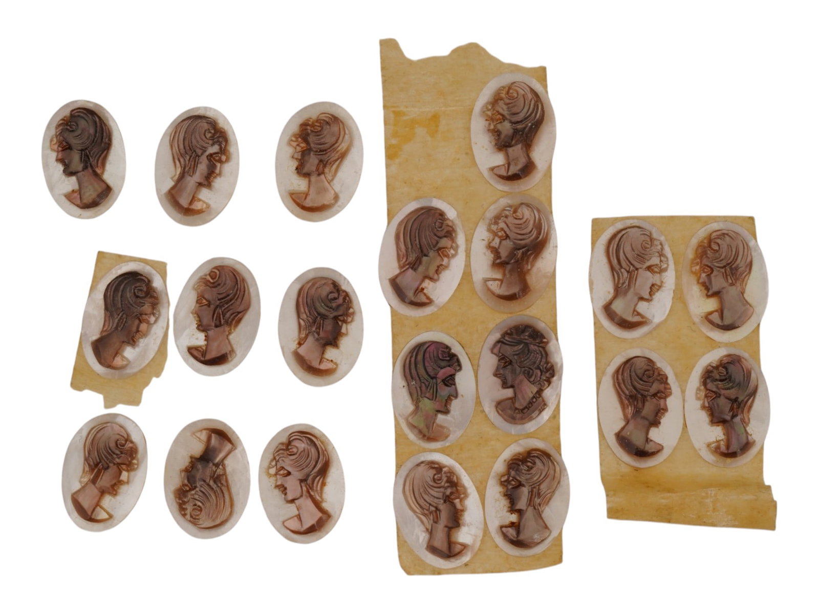 COLLECTION OF HAND CARVED SHELL CAMEO MEDALLIONS: A collection of vintage hand carved cameo medallions. A total of 20 items. Each piece is crafted from conch shell featuring a female portrait in the Victorian manner rendered in high relief. The cameo