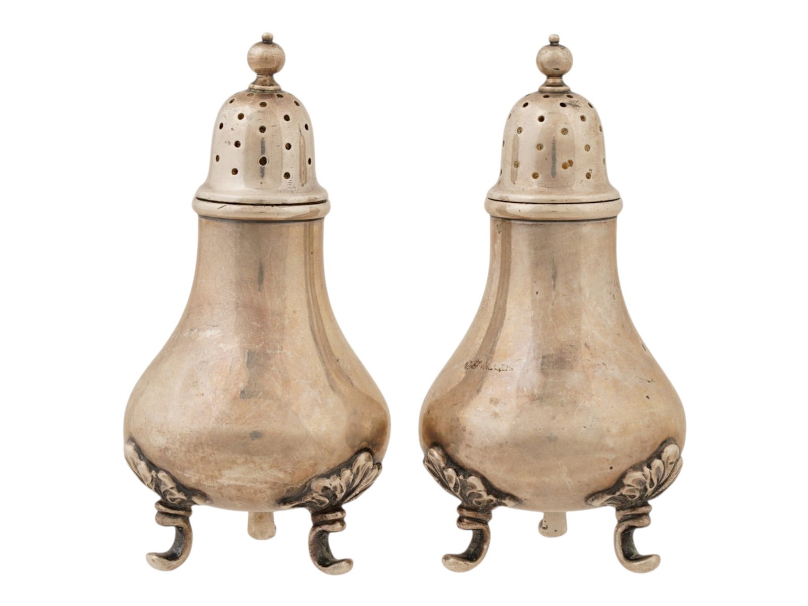 STERLING SILVER SALT PEPPER SHAKERS BY TIFFANY CO: A pair of American salt and pepper shakers by Tiffany and Co. The items are crafted from sterling silver and have a classic, elegant design. The shakers have a bulbous, urn like shape with a round, wi