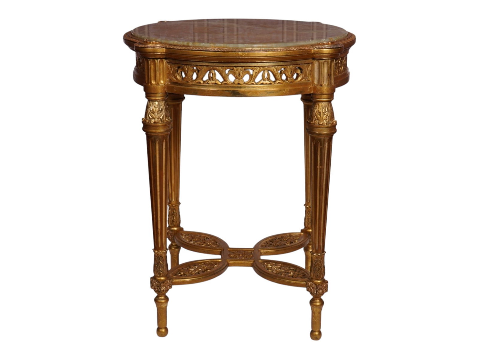 FRENCH LOUIS XVI GILT WOOD ONYX GUERIDON SIDE TABLE: An antique late 19th-century French side table. Louis XVI style. The circular gilt wood carved apron with a leaf wreath, raised on four fluted carved legs conjoined with a quatrefoil stretcher, fitted
