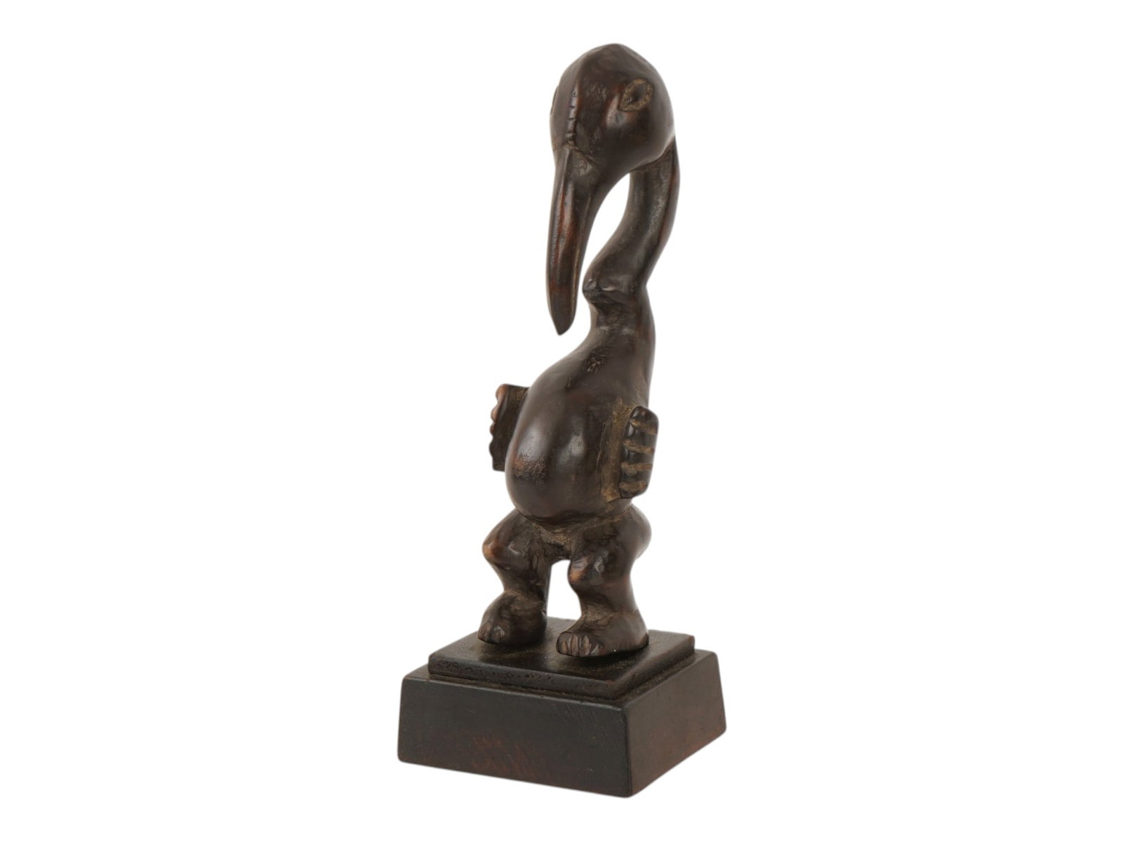 CENTRAL AFRICAN CARVED FIGURE FROM BAMILEKE PEOPLE: A carved sculpture from the Bamileke people, Cameroon, Central Africa. The work depicts a stylized anthropomorphic figure in a squatting posture atop a square, tiered pedestal base. The figure combine