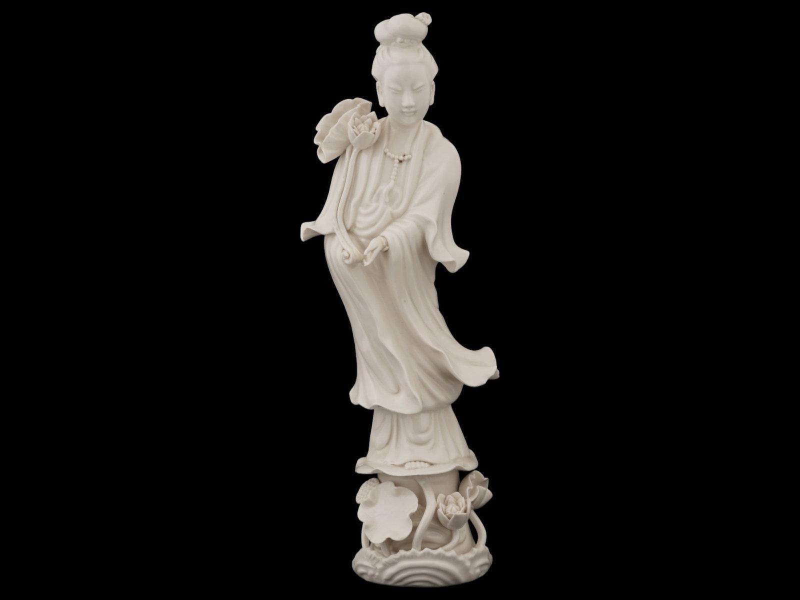 CHINESE BLANC DE CHINE PORCELAIN GUANYIN FIGURE: An antique Chinese, Late Qing dynasty, Blanc de Chine porcelain sculpture. Circa: late 19th century. The artwork represents Guanyin, a character of Chinese, Vietnamese, Korean, and Japanese mythology,