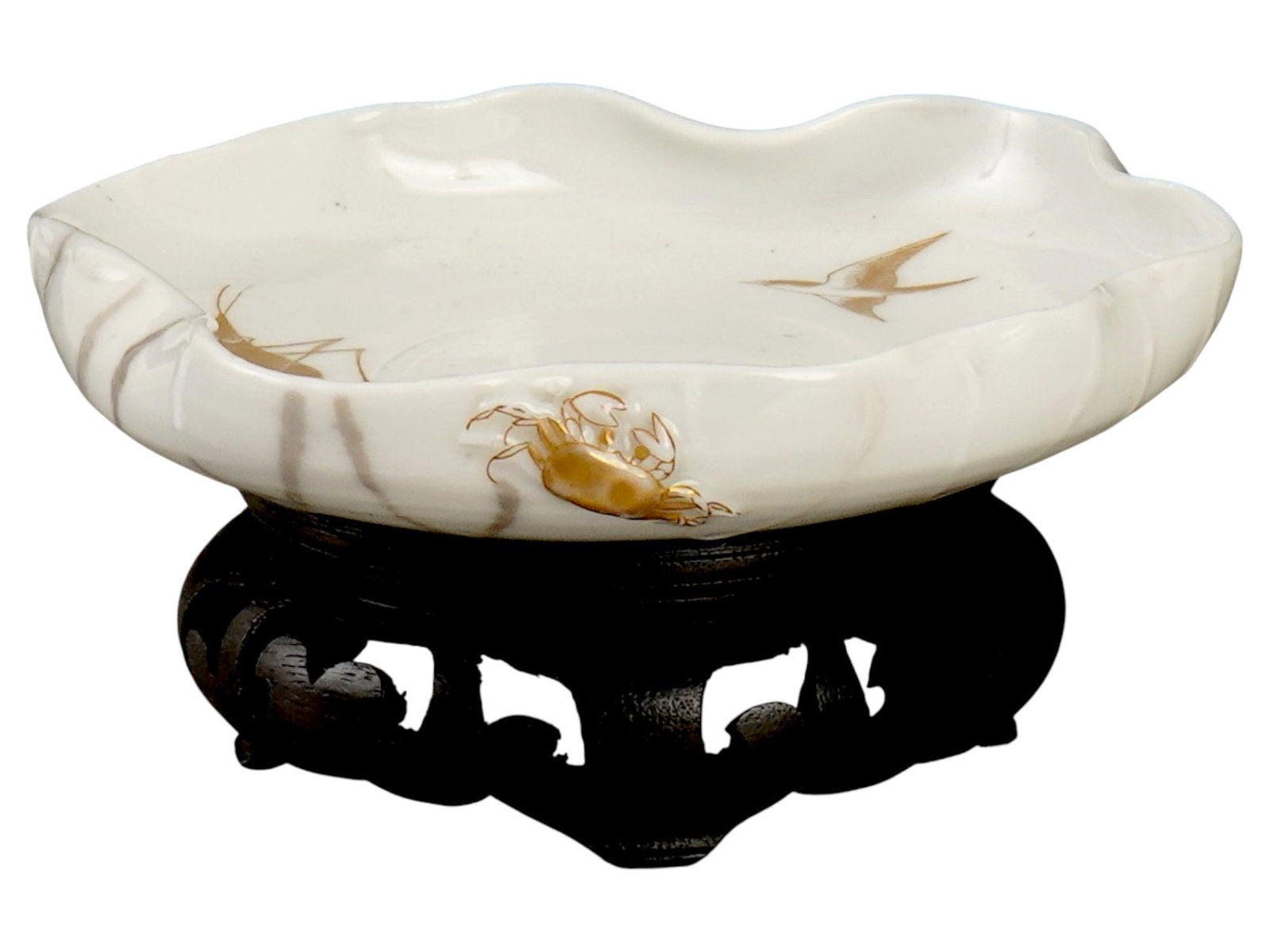 CHINESE LATE QING DYNASTY HAND PAINTED PORCELAIN BOWL: A Chinese late Qing Dynasty porcelain bowl placed on a traditional carved wooden stand. The piece is shaped like an open lotus leaf with soft, wavy edges. The snow white surface is gracefully embossed