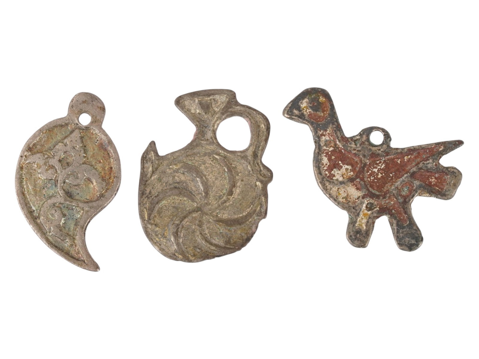 GROUP OF ANCIENT ROMAN SILVER PENDANTS 300 TO 500 AD: A lot of three ancient Judaica Silvers pendants dating to the Late Roman or early Byzantine period, approximately 300 to 500 AD, originating from the Holy Land. The collection includes a zoomorphic pe