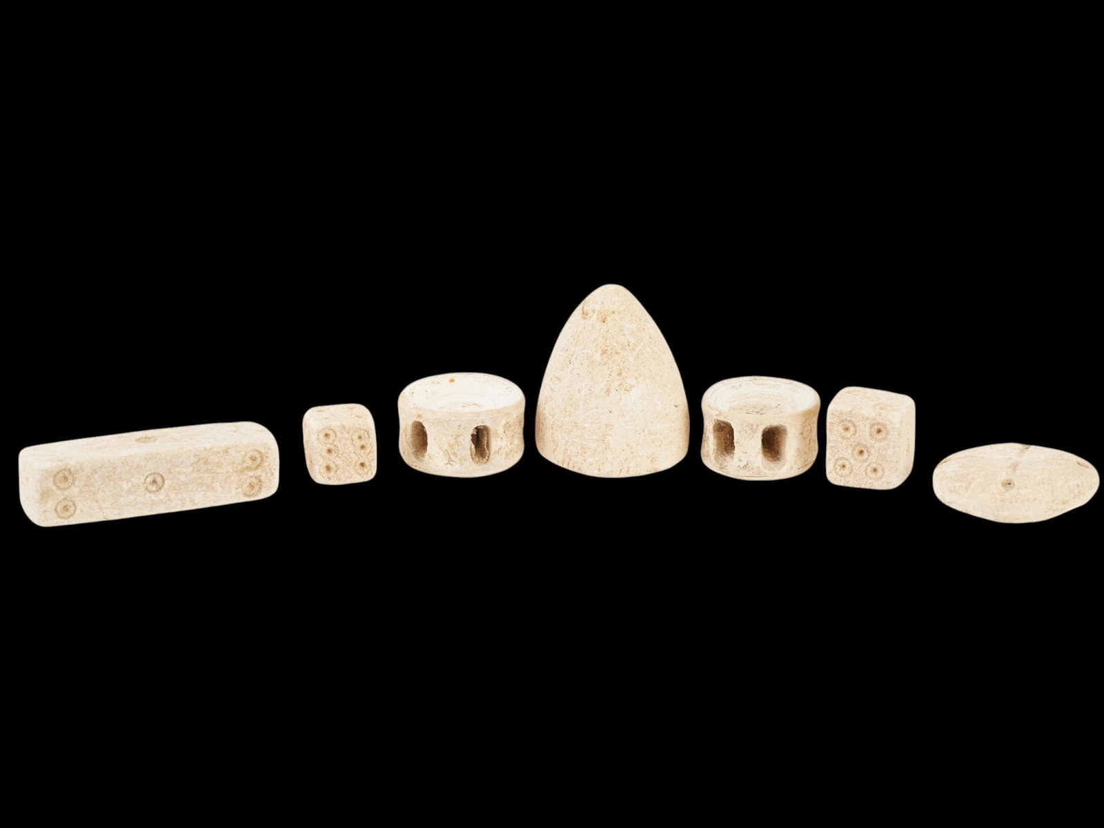 LOT ANCIENT GRECO ROMAN GAMING PIECES 1ST MILLENNIUM BC: A group of seven ancient Roman gaming pieces. Circa: 1st Millennium BC. The lot includes handcrafted gaming pieces, including dice of various shapes made from natural materials. Historical Collectible