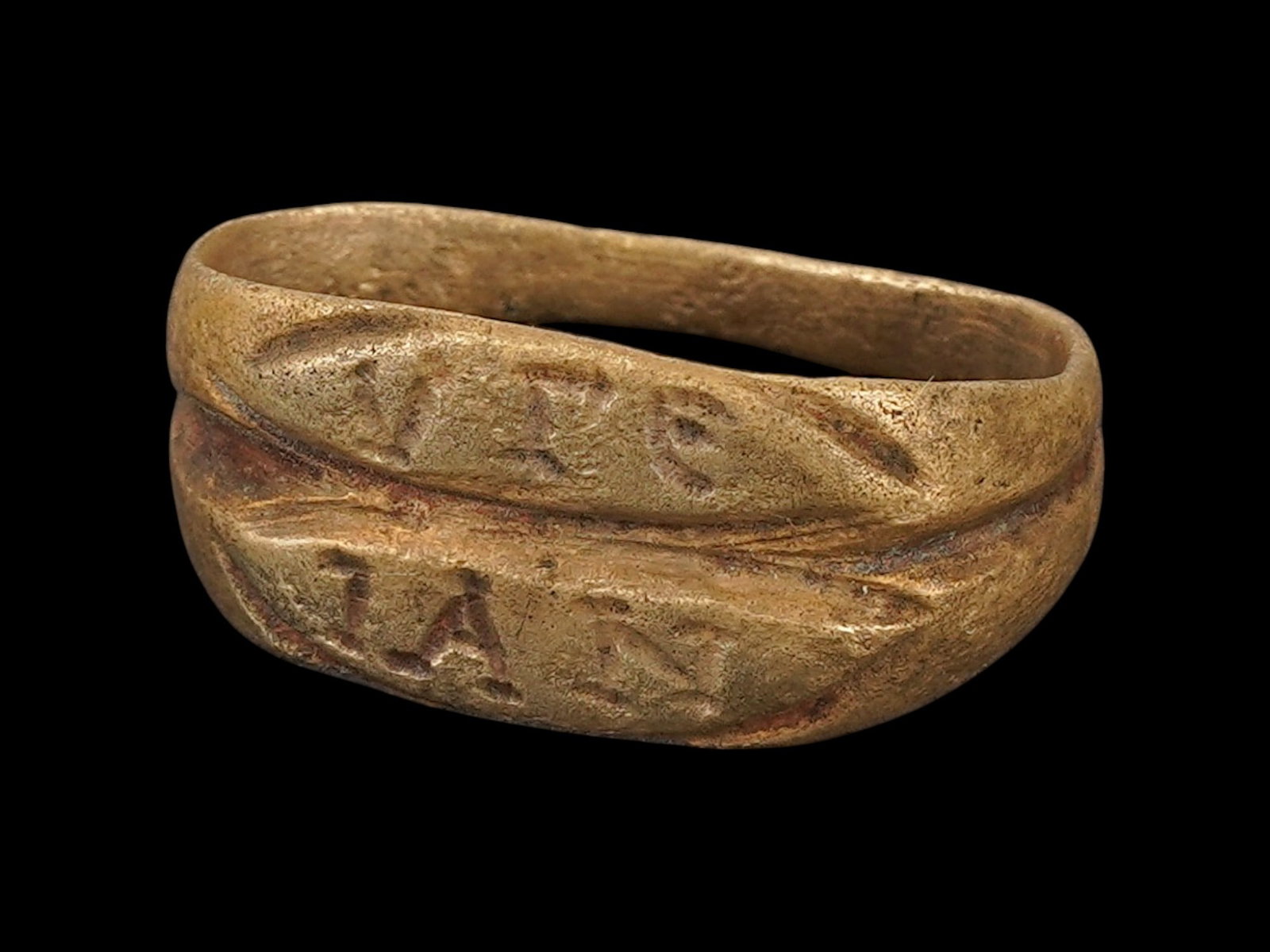 ANCIENT ROMAN BRONZE SIGNET RING CA 100 TO 300 AD: An ancient Roman bronze signet ring, dating circa 100 to 300 AD, features two central lines engraved with inscriptions on each. Ancient Roman Rings And Jewelry Wares, Museum Pieces, and Collectibles. 