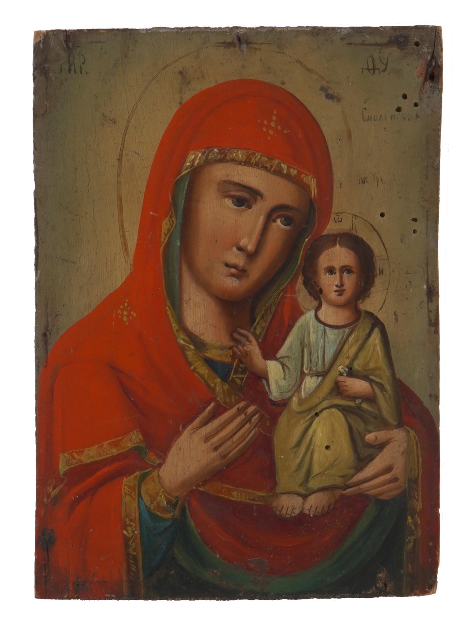 ANTIQUE RUSSIAN ICON SMOLENSK MOTHER OF GOD: An early 20th-century Russian Orthodox icon of Smolensk Mother of God. Mixed media painting: egg tempera, gesso, and levkas on a wood board. Titled in Church Slavonic in the upper part. Virgin of Smol