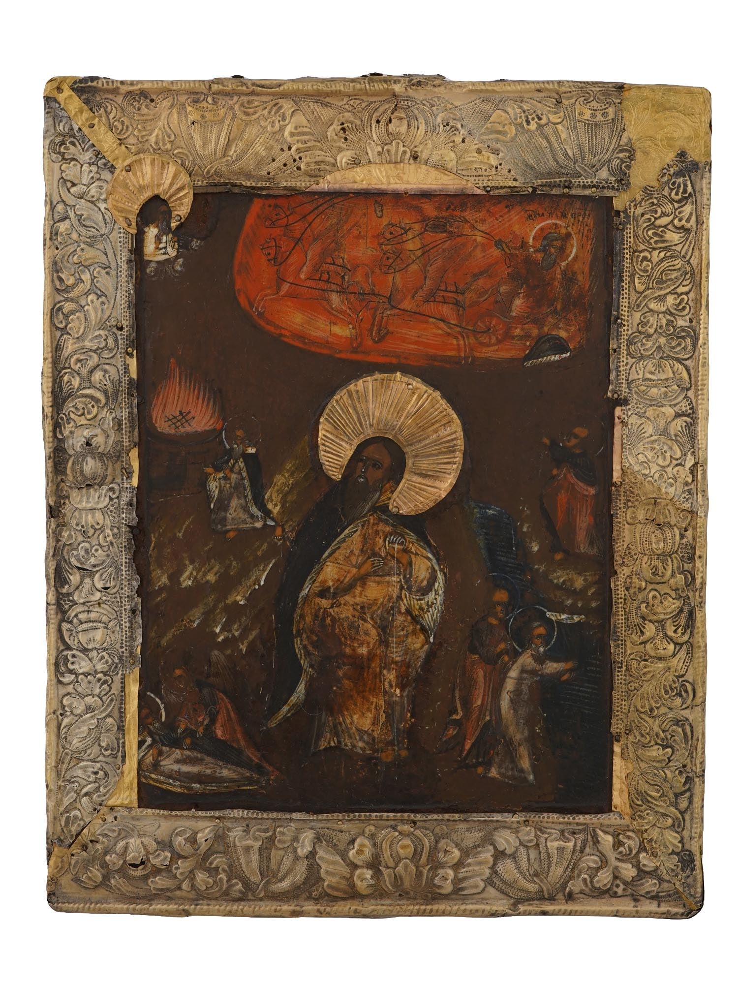 ANTIQUE RUSSIAN ICON APOCALYPSE IN SILVER OKLAD: An antique 19th-century Russian Orthodox icon representing an apocalyptic scene, presumably with Saint Elijah. Mixed media painting: egg tempera, gesso, and levkas on a wood board. Gilt silver riza or