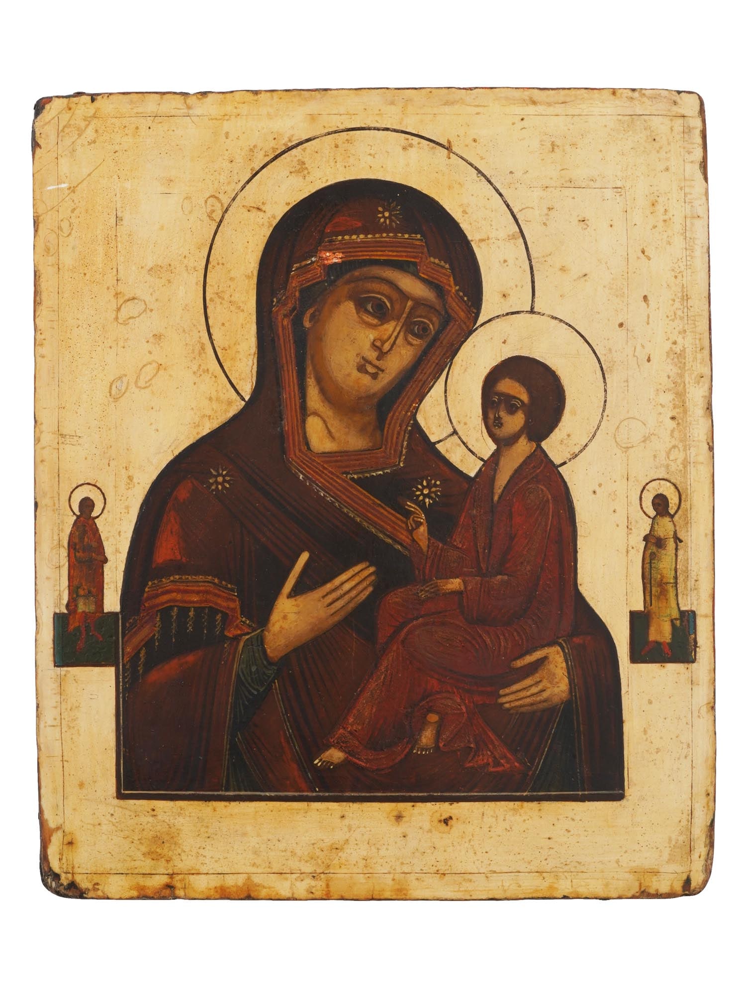 ANTIQUE 19TH C RUSSIAN ICON VIRGIN OF TIKHVIN: An antique 19th-century Russian Orthodox icon of Mother of God with Jesus Child in Tikhvinskaya iconography, flanked by two saints. Mixed media painting: egg tempera, gesso, and levkas on a wood