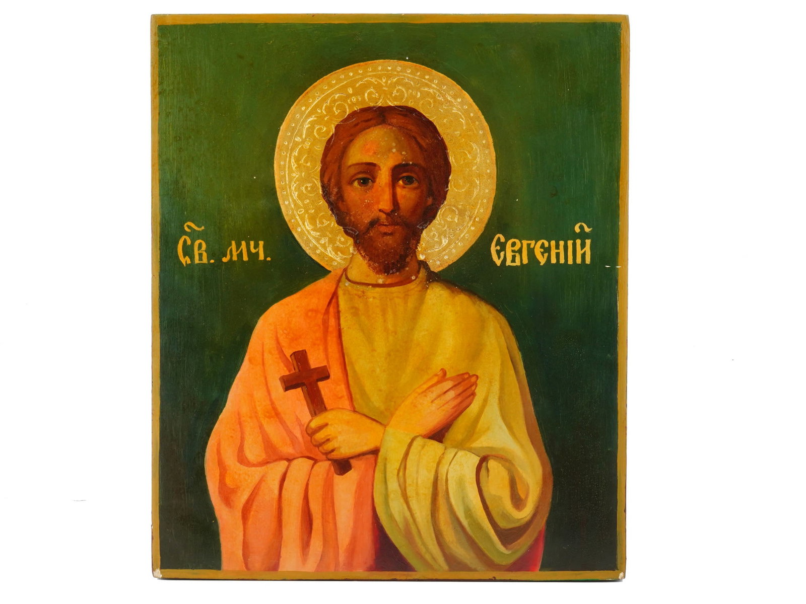ANTIQUE RUSSIAN ORTHODOX ICON OF SAINT YEVGENY: An antique Russian Orthodox icon of Saint Yevgeny or Eugene. Hand painted in egg tempera, gesso, gold leaf and levkas on a wood board with raised kovcheg borders. Saint Yevgeny is depicted with an