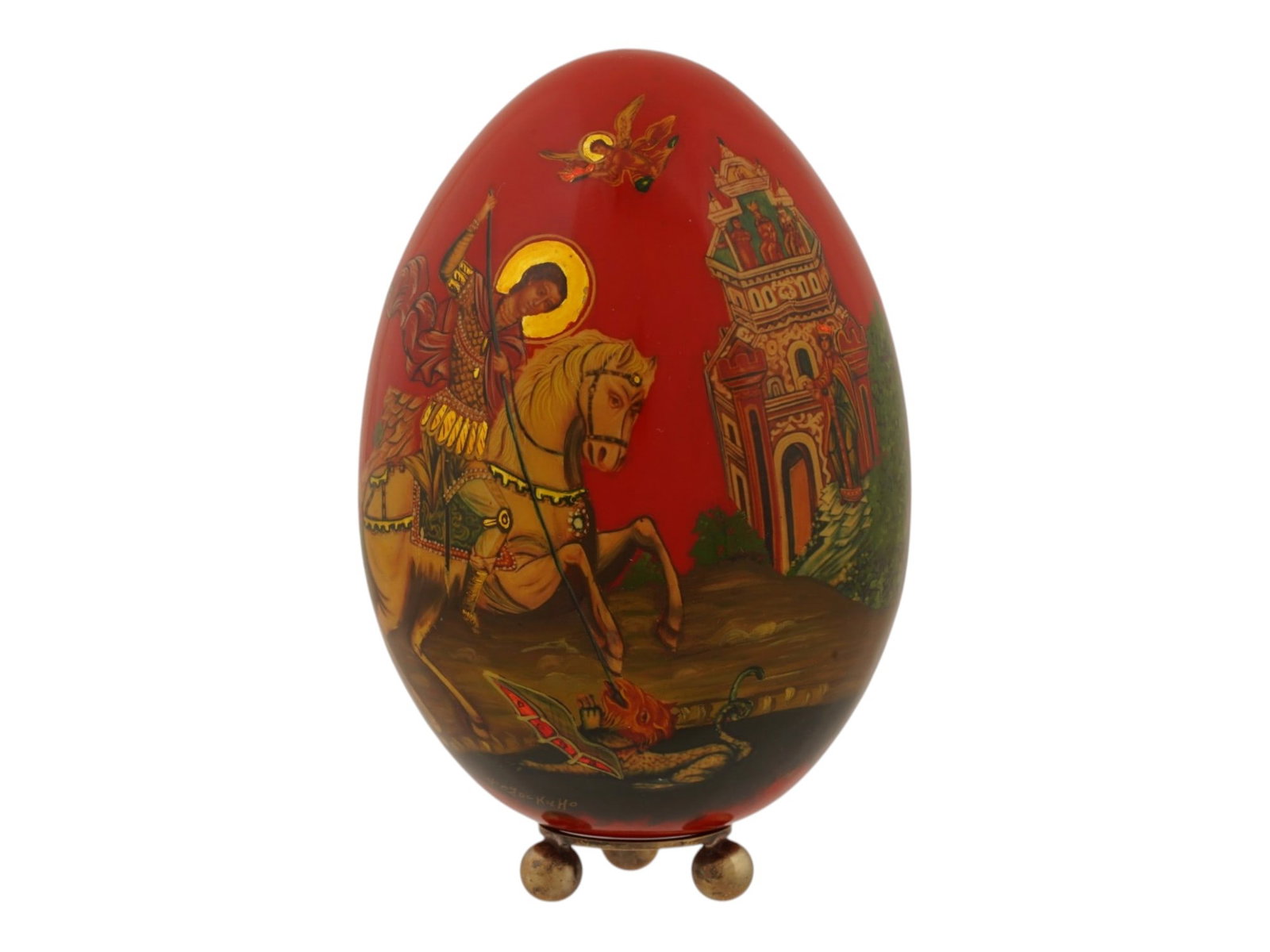 LARGE RUSSIAN LACQUERED WOOD SAINT GEORGE EASTER EGG: A large Russian lacquered wood Easter egg, hand-painted with the Orthodox icon of Saint George and the Dragon, with the traditional abbreviation for Christ Has Risen on the reverse. Executed in the