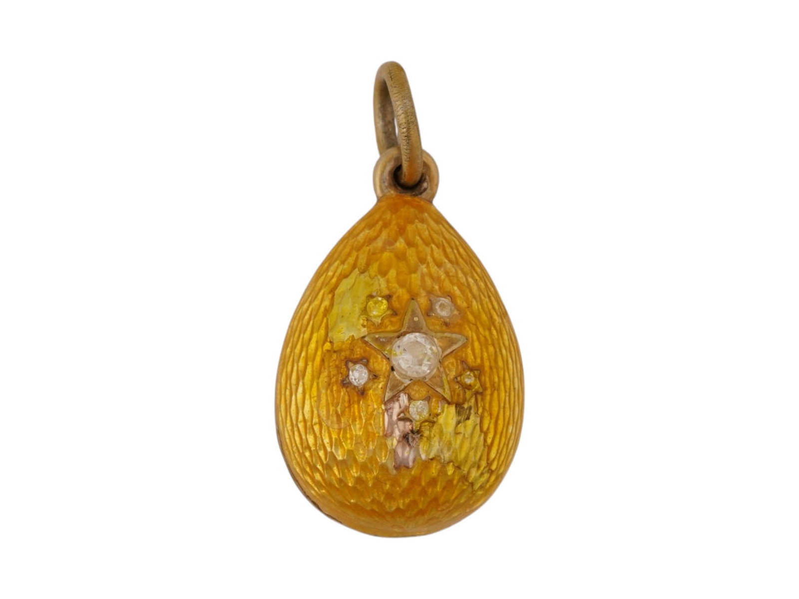 RUSSIAN SILVER GILT GUILLOCHE ENAMEL EASTER EGG PENDANT: A Russian gilt silver guilloche enamel miniature Easter egg pendant. Features translucent amber enamel over an engine-turned ground, accented with a starburst motif set with faceted stones and finishe