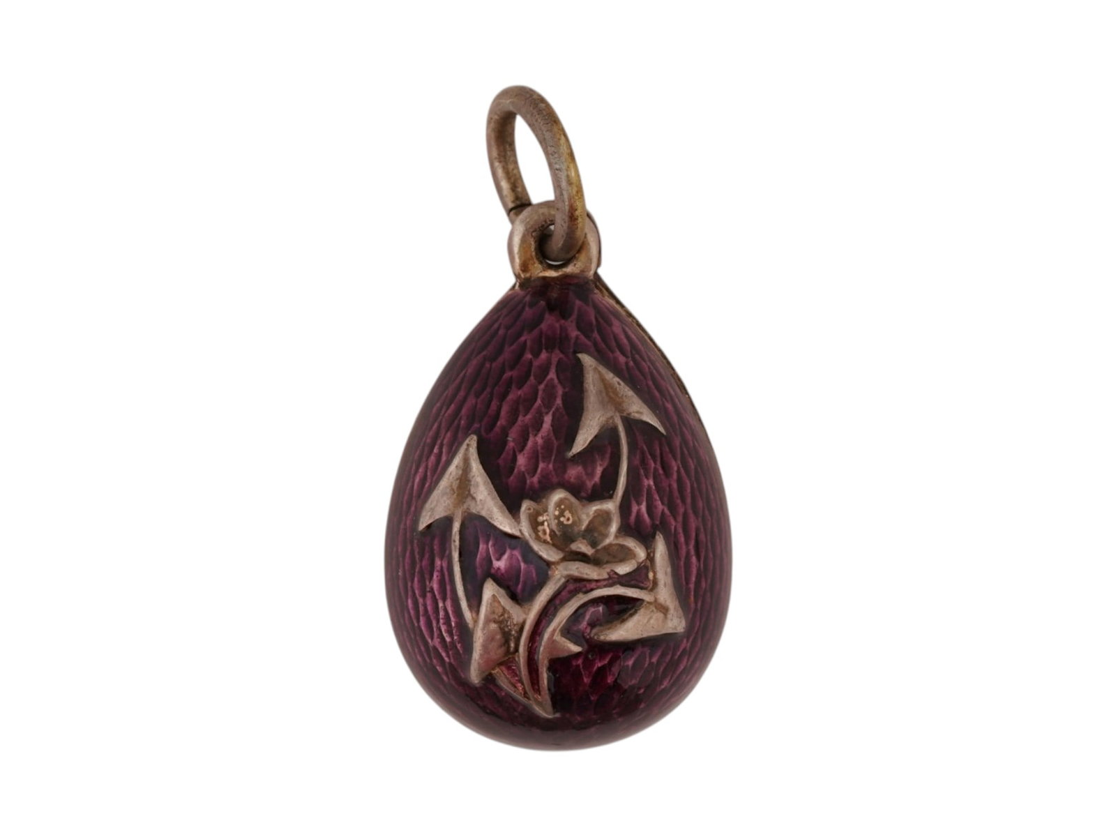 RUSSIAN SILVER GUILLOCHE ENAMEL EASTER EGG PENDANT: A Russian gilt silver Easter egg pendant. The pendant is decorated with a relief image of a flower on the front side. Covered with shimmering purple enamel. Marked on the fitting ring with an 88