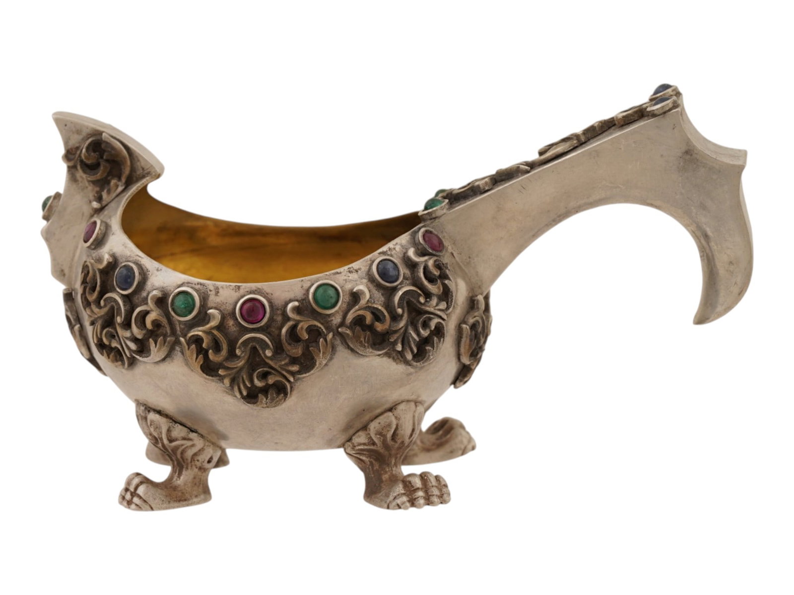 RUSSIAN 84 SILVER KOVSH SET WITH GEMSTONES: A Russian silver kovsh of an oval form with a pronounced front. Features a gold washed interior, a curved handle and an ovoid body set with round cabochon cut gemstones. Decorated with foliate