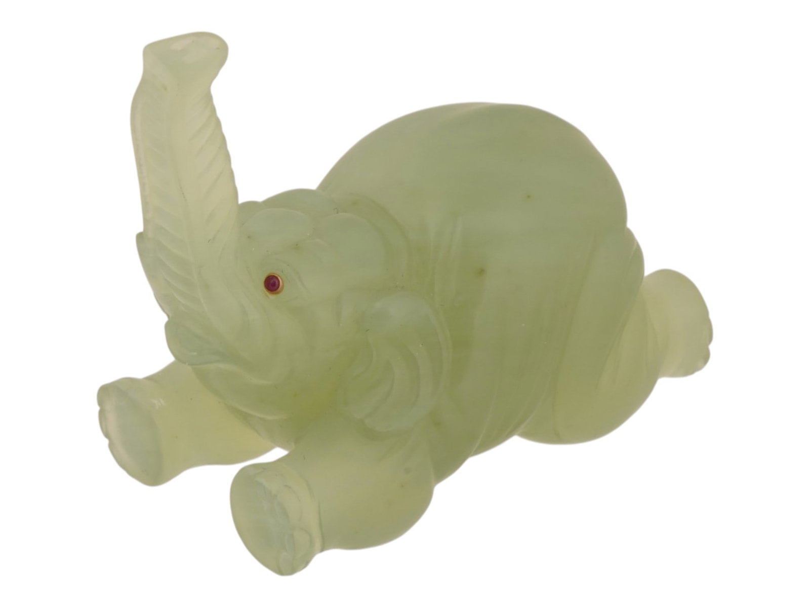 RUSSIAN CARVED BOWENITE GOLD AND RUBY ELEPHANT FIGURE: A Russian carved bowenite figurine of an elephant. The eyes are inlaid with rubies in gold fittings. Unmarked. Total Weight: 80 g. Collectible Russian Jewelry And Decor. THIS LOT IS ELIGIBLE FOR A