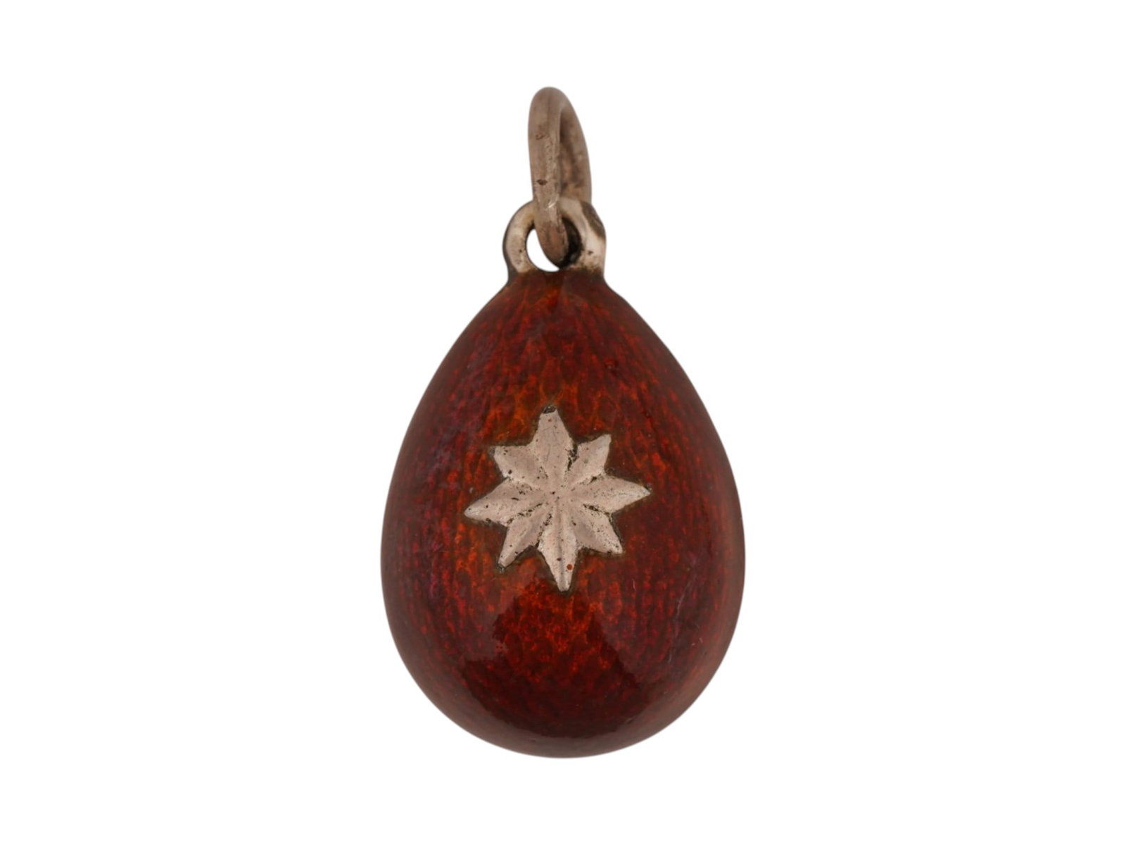 RUSSIAN SILVER GUILLOCHE ENAMEL EASTER EGG PENDANT: A Russian silver Easter Egg pendant with red guilloche enamel surface. Star motif on the obverse. Hallmark of 88 silver standard and makers mark are on the fitting ring. Total Weight: 6.34 g. Russian