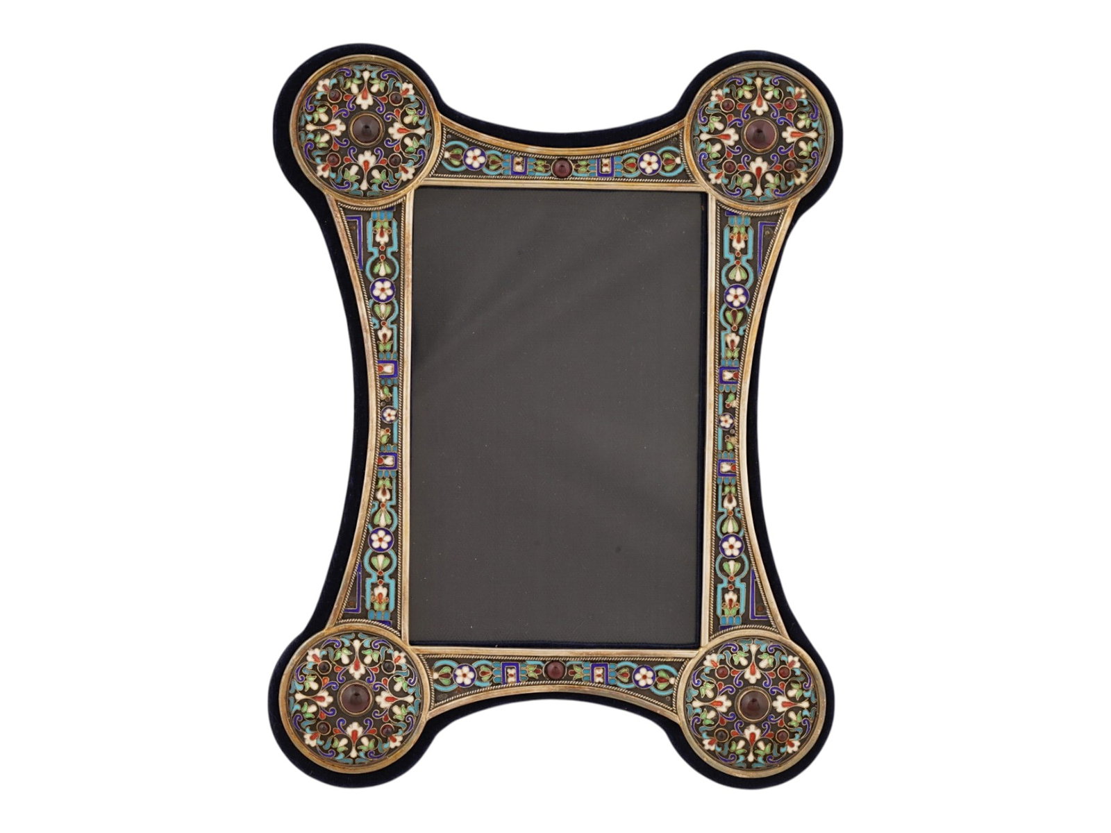 RUSSIAN SILVER ENAMEL PICTURE FRAME WITH GEMSTONES: A Russian silver and enamel standing picture frame. Art Nouveau shape with enlarged rounded corners. The piece is decorated with polychrome floral, foliage and foliate scroll cloisonne enamel