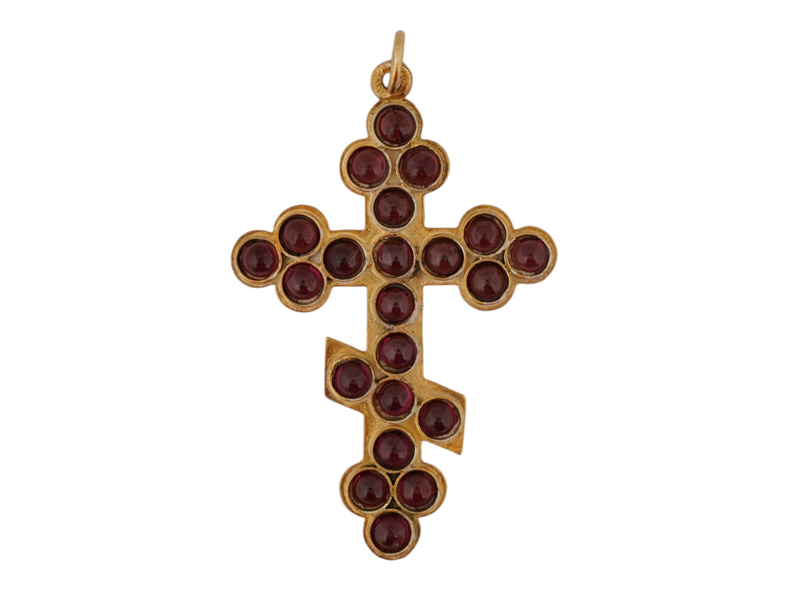 RUSSIAN 88 GILT SILVER CROSS PENDANT WITH GARNETS: A Russian 88 gilt silver Orthodox cross crucifix pendant set with cabochon cut garnets throughout the front side. Hallmarked on the fitting ring with an 88 Russian Imperial silver standard and makers