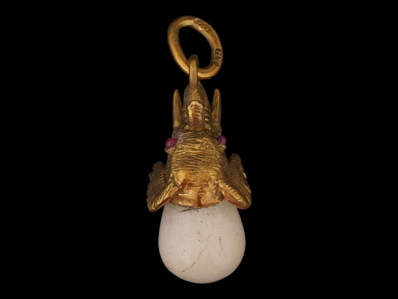 RUSSIAN JADE RUBIES ELEPHANT EASTER EGG PENDANT: A Russian carved white jade Easter egg pendant with a figurative gilt silver upper part representing an elephant. The eyes of the figurine are set with rubies. Hallmarked with the 84 silver standard