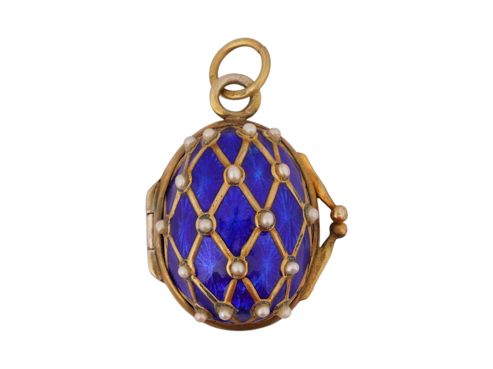 RUSSIAN SILVER ENAMEL PEARL LOCKET EASTER EGG PENDANT: A large Russian gilt silver Easter Egg-shaped locket pendant. The surface is garnished with cobalt blue enamel, lozenge design, cultured pearls. Hallmark of 88 silver standard and makers mark are on