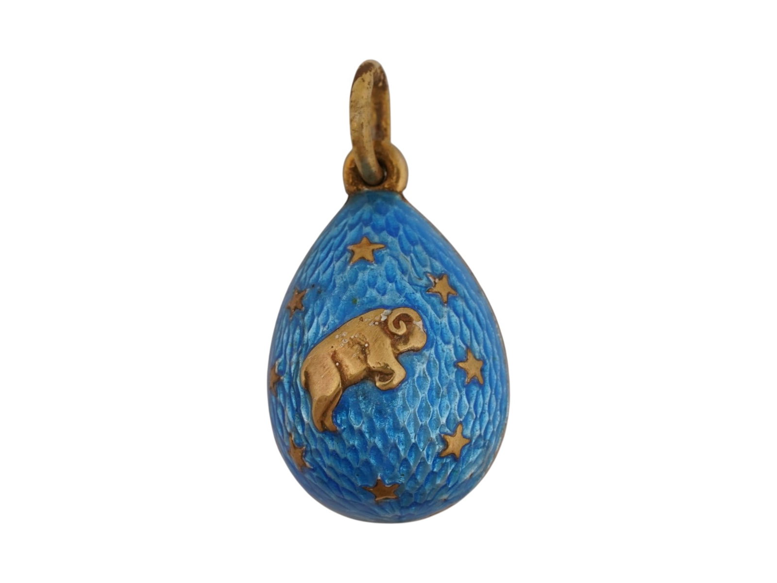 RUSSIAN SILVER GUILLOCHE ENAMEL EASTER EGG PENDANT: A Russian gilt silver egg shaped pendant. Blue guilloche enamel surface. Aries zodiac sign and stars overlay on both sides. Hallmarks of 84 Russian silver standard and makers mark are on the fitting