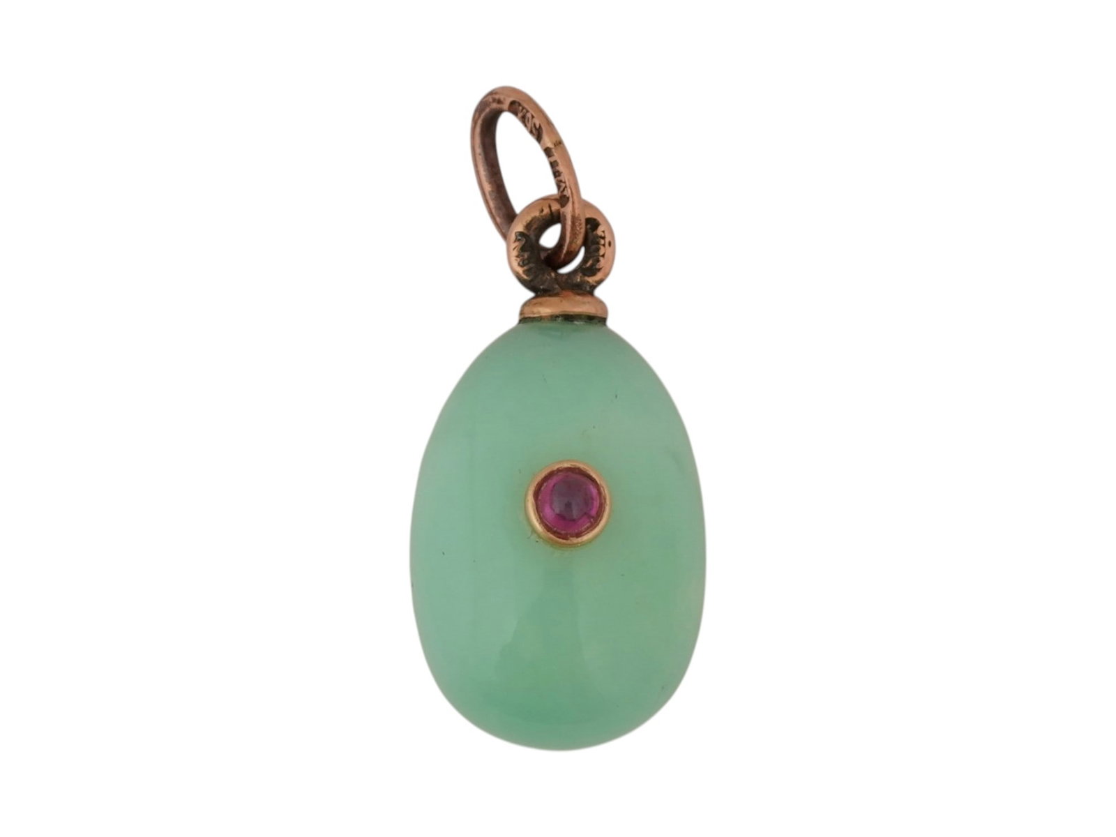 RUSSIAN GOLD AND CARVED CHRYSOPRASE EASTER EGG PENDANT: A Russian miniature Easter egg pendant hand-carved from chrysoprase and mounted in gold. The pendant is accented with a ruby cabochon in a gold bezel and fitted with a gold suspension cap and hanging