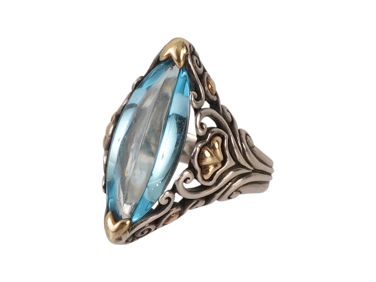 JOHN HARDY 18K GOLD SILVER SKY BLUE TOPAZ RING: A designer cocktail ring by John Hardy, crafted in Bali from 925 sterling silver and solid 18K yellow gold. The centerpiece features a prominent marquise-cut sky blue topaz, secured in a stylized