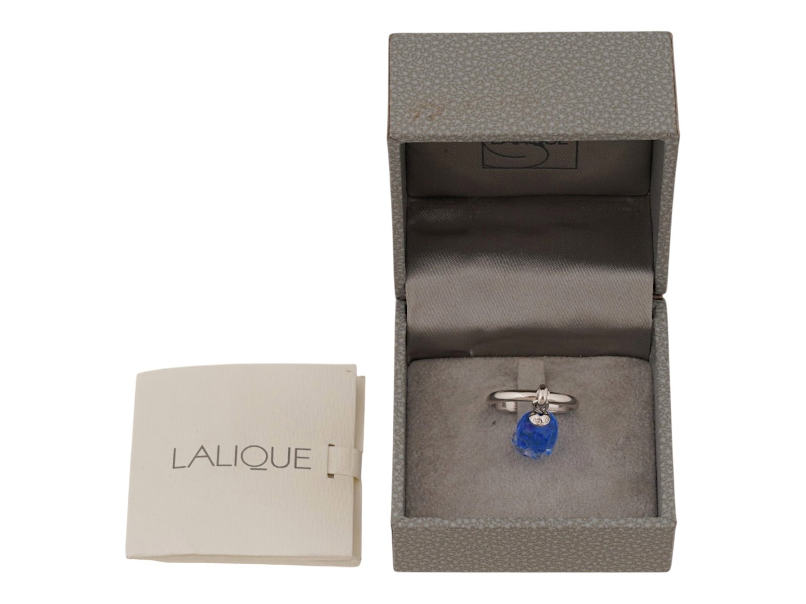 VINTAGE LALIQUE MUGUET STERLING SILVER CHARM RING: A vintage Lalique sterling silver charm ring from the celebrated Muguet collection. The design features a suspended blue crystal pendant modeled as a delicate lily-of-the-valley blossom. Finished