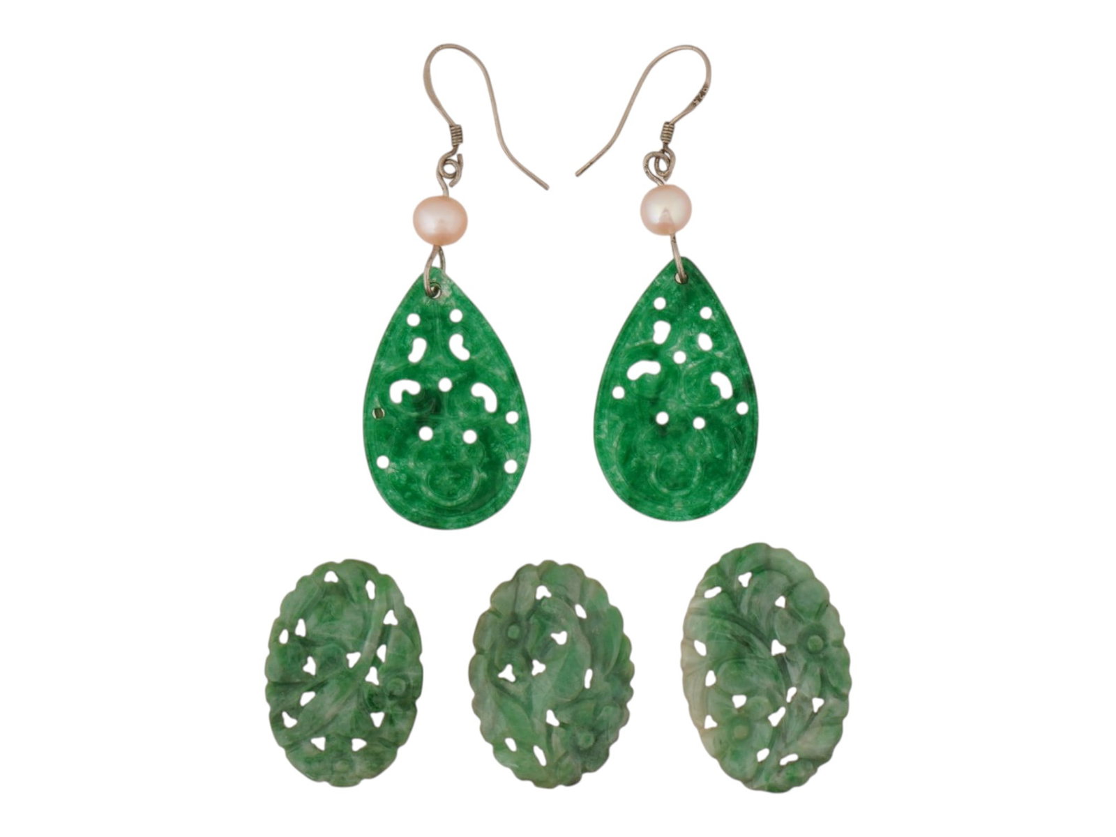 LOT OF CHINESE CARVED JADE PLAQUES PAIR OF EARRINGS: A lot of five carved stone pieces. The lot includes a pair of drop earrings and three loose plaques, each crafted from carved green jadeite. The earrings feature pear shaped plaques with fine