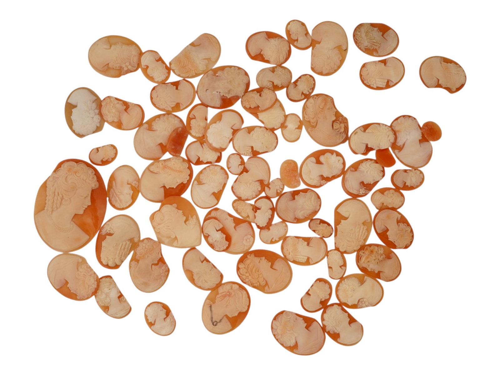 LARGE COLLECTION OF DAMAGED SHELL CAMEO MEDALLIONS: A large collection of assorted damaged hand carved cameo medallions in various sizes. Each piece is crafted from conch shell featuring a female portrait in the Victorian and Roman manners rendered in 