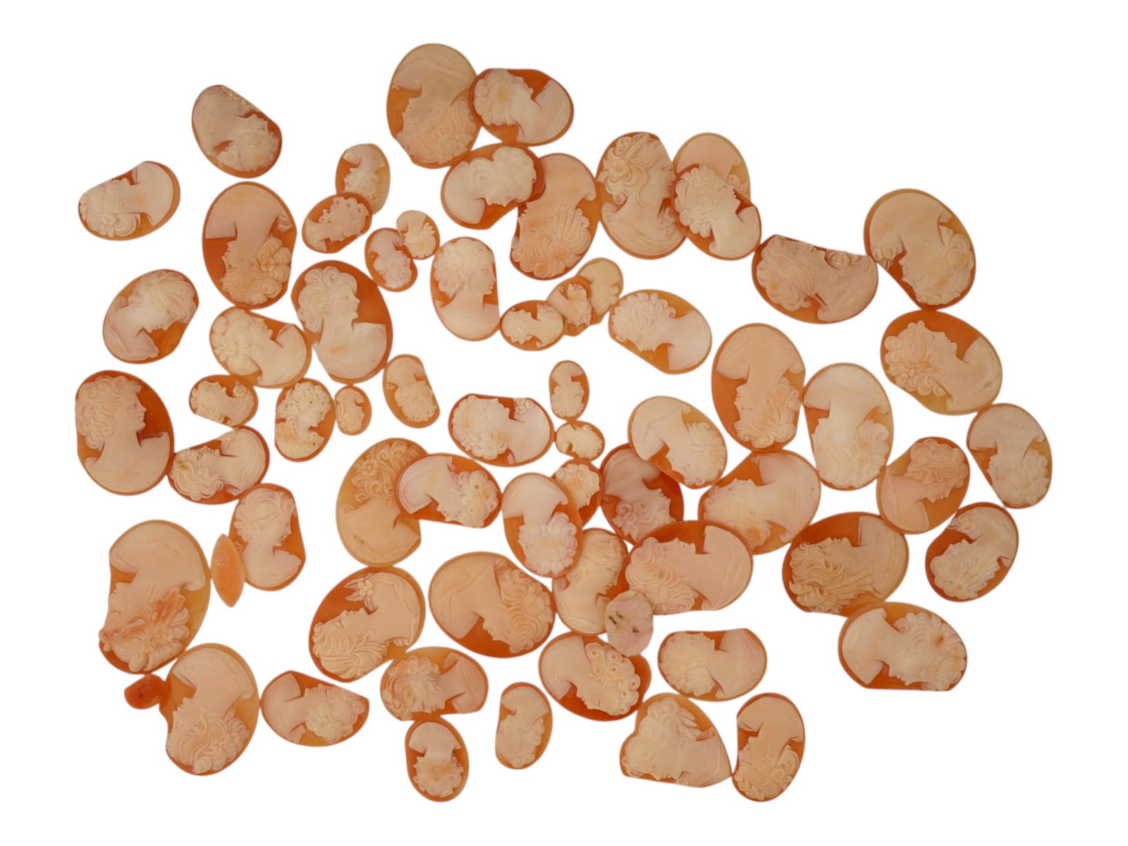 LARGE COLLECTION OF DAMAGED CONCH SHELL CAMEOS: A large collection of damaged hand carved cameo medallions. Each piece is crafted from a conch shell, and most depict female portraits in the Victorian manner rendered in high relief. The cameos are p