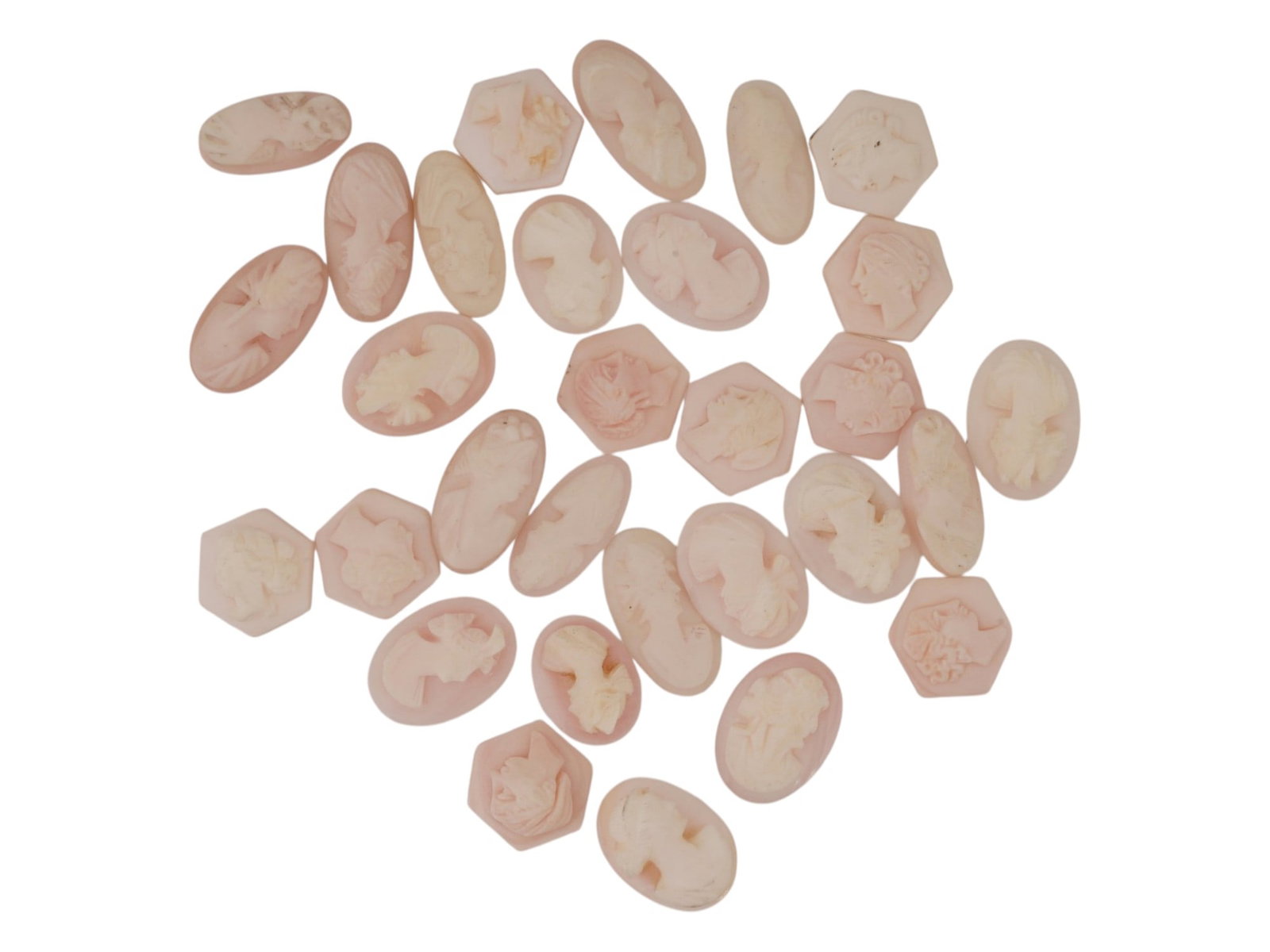COLLECTION OF HAND CARVED CORAL CAMEO MEDALLIONS: A collection of vintage hand carved cameo medallions. A total of 30 items. Each piece is crafted from coral featuring a female portrait in the Victorian and Roman manners rendered in high relief. The 