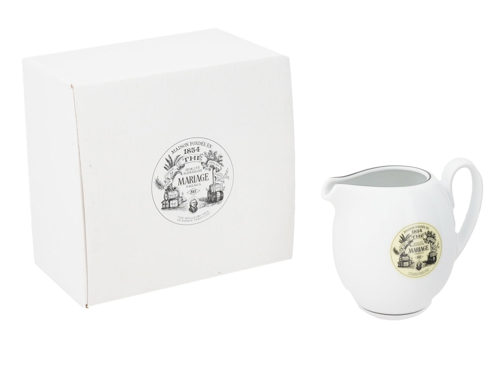 FRENCH MARIAGE FRERES WHITE PORCELAIN MILK JUG IOB: A French Mariage Freres white porcelain designed milk jug from the teahouse in Paris. A body is adorned with a medallion with a brand logo, and a curved handle. Presented in an original box, marked.