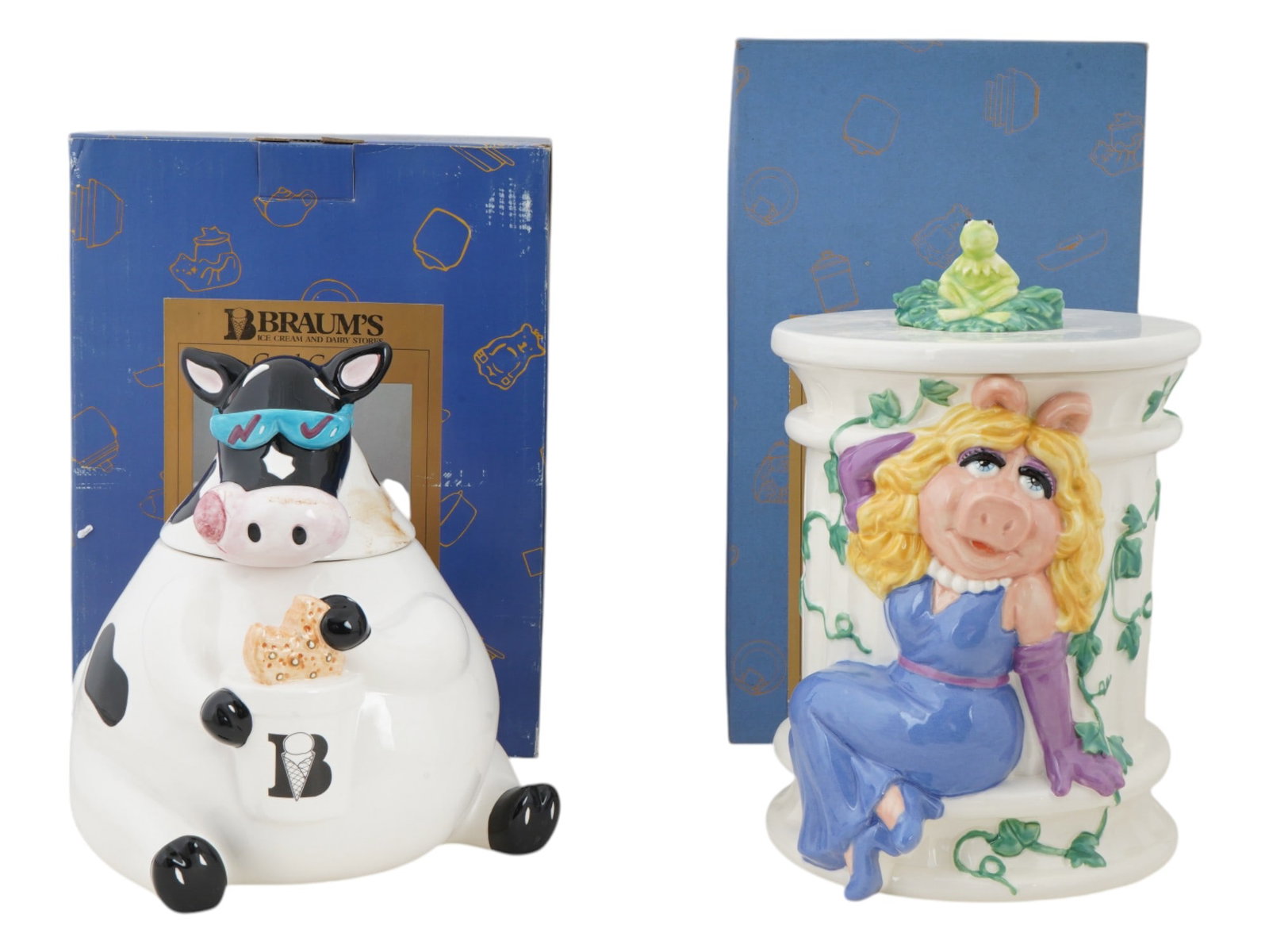 MISS PIGGY AND COW FIGURAL PAINTED CERAMIC COOKIE JARS: A lot of two vintage figural painted ceramic cookie jars. The first jar is modeled after a black and white cow wearing sunglasses, while the second is decorated with an image of the Muppet character M