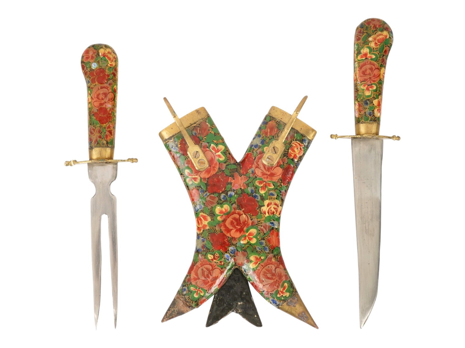 VINTAGE INDIAN LACQUERED FLORAL MEAT CARVING SET: A mid-20th century traditional Indian meat carving set, a fork and knife presented in a matching painted case or sheath with moveable stand. Lacquered floral designs on the handles and fine brass fitt