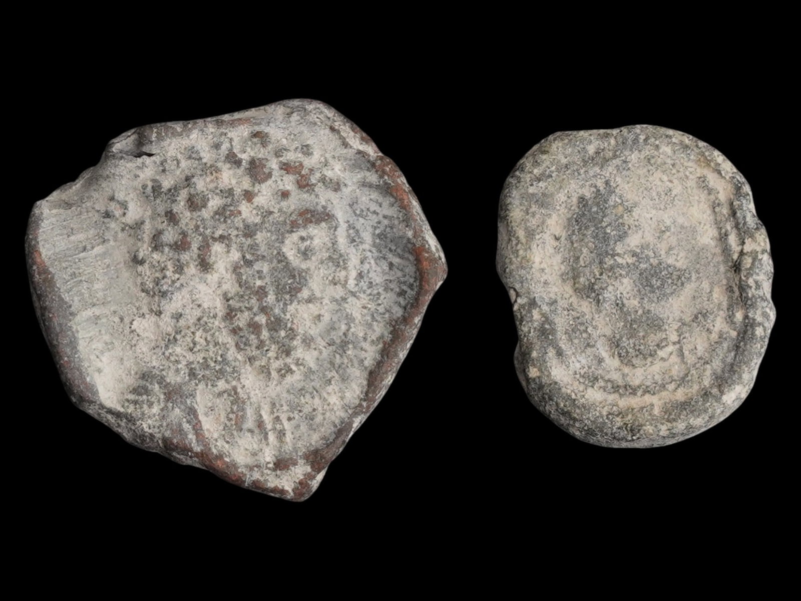 ANCIENT ROMAN LEAD SEALS CIRCA 100 TO 300 AD: A lot of two ancient Roman lead seals. Circa 100 to 300 AD. Both seals are irregular in shape and depict traces of portrait images, possibly of emperors. Archaeological and Historical Wares, Jewelry W